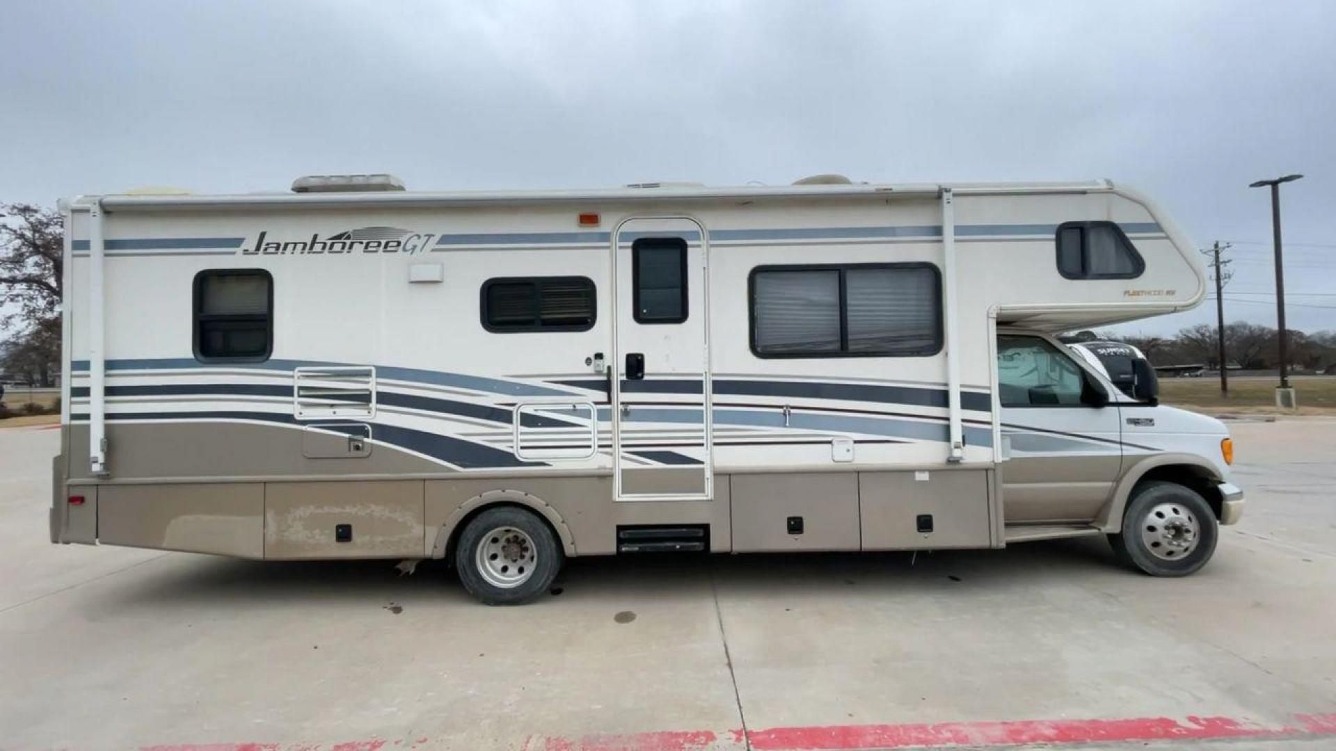 2003 WHITE FLEETWOOD JAMBOREE GT E450 (1FDXE45S93H) with an 6.8L V10 SOHC 20V engine, located at 4319 N Main Street, Cleburne, TX, 76033, (817) 221-0660, 32.435829, -97.384178 - The 2003 Fleetwood Jamboree GT allows you to enjoy the beauty of nature. Experience the ultimate in RV luxury with rear roof access, providing unparalleled views from the comfort of your mobile abode. With a spacious awning and a slide-out feature, you'll have plenty of room to enjoy the outdoors an - Photo#2