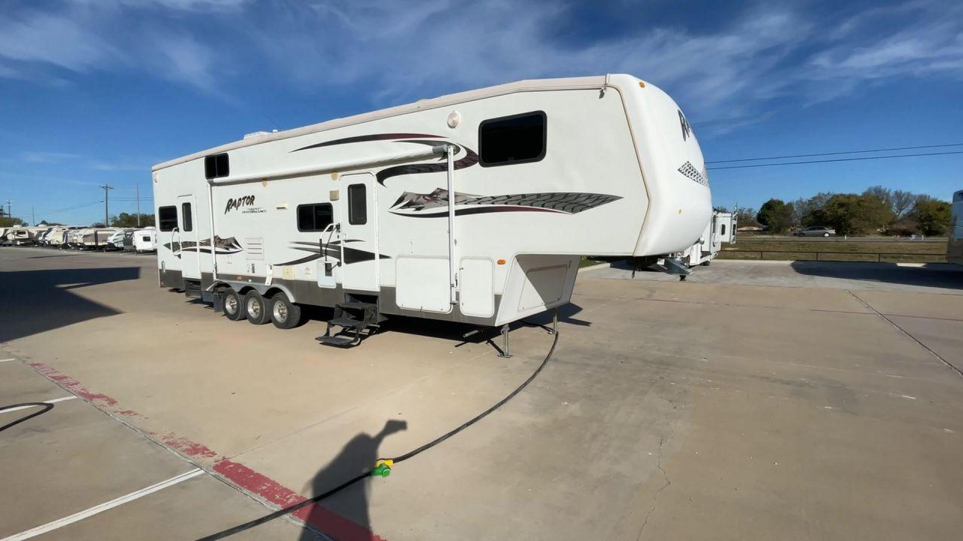 2006 KEYSTONE RAPTOR (4YDF361376M) , Length: 37.58 ft | Dry Weight: 11,615 lbs | Slides: 2 transmission, located at 4319 N Main Street, Cleburne, TX, 76033, (817) 221-0660, 32.435829, -97.384178 - The 2016 Keystone Raptor RP3612 is a fifth-wheel toy hauler with a bold and functional exterior. It features a white body with stylish decals that include swooping lines and mountain graphics, giving it a sporty and adventurous look. The RV has three axles, offering stability and support for its lar - Photo#3