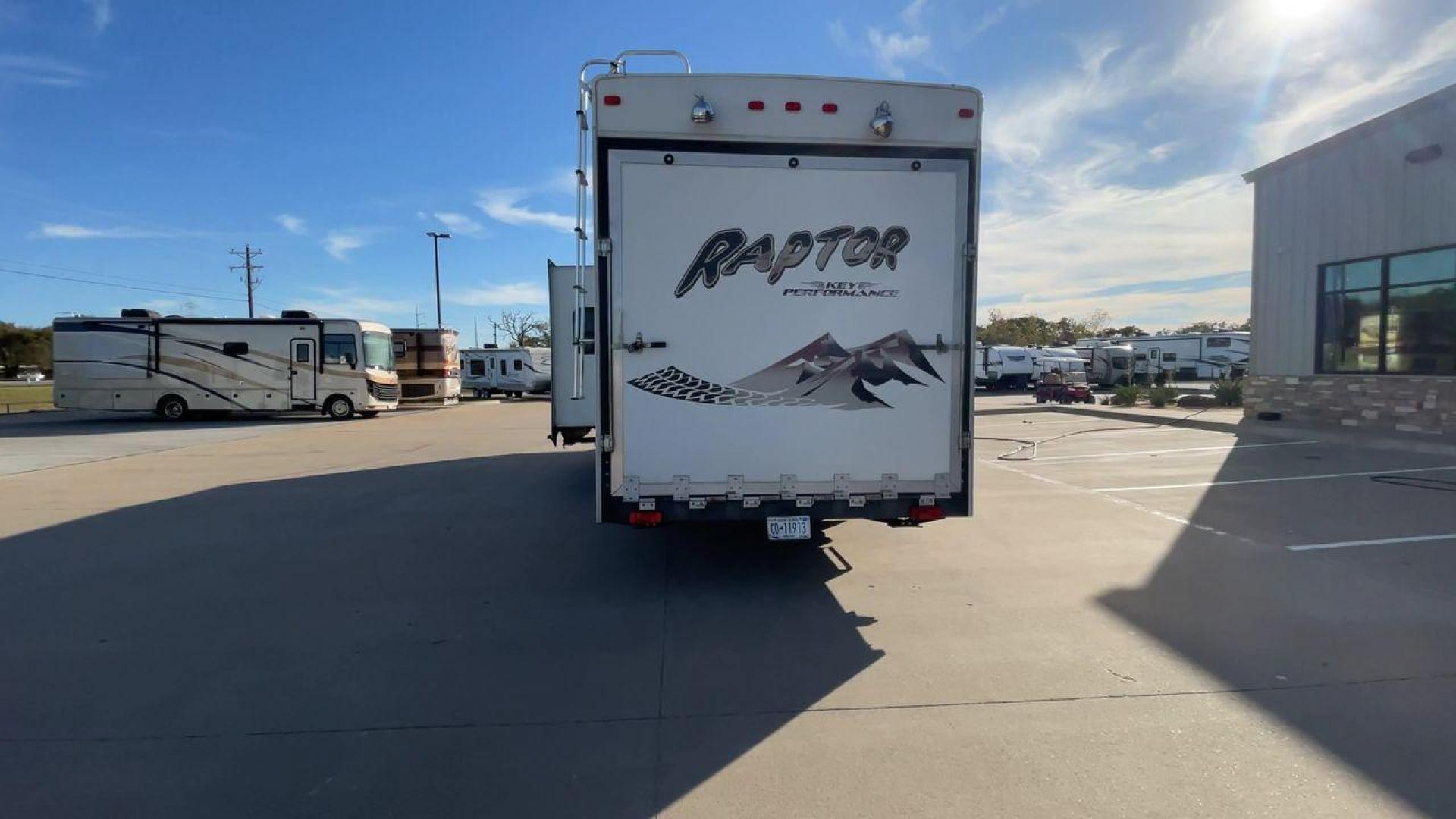 2006 KEYSTONE RAPTOR (4YDF361376M) , Length: 37.58 ft | Dry Weight: 11,615 lbs | Slides: 2 transmission, located at 4319 N Main Street, Cleburne, TX, 76033, (817) 221-0660, 32.435829, -97.384178 - The 2016 Keystone Raptor RP3612 is a fifth-wheel toy hauler with a bold and functional exterior. It features a white body with stylish decals that include swooping lines and mountain graphics, giving it a sporty and adventurous look. The RV has three axles, offering stability and support for its lar - Photo#8