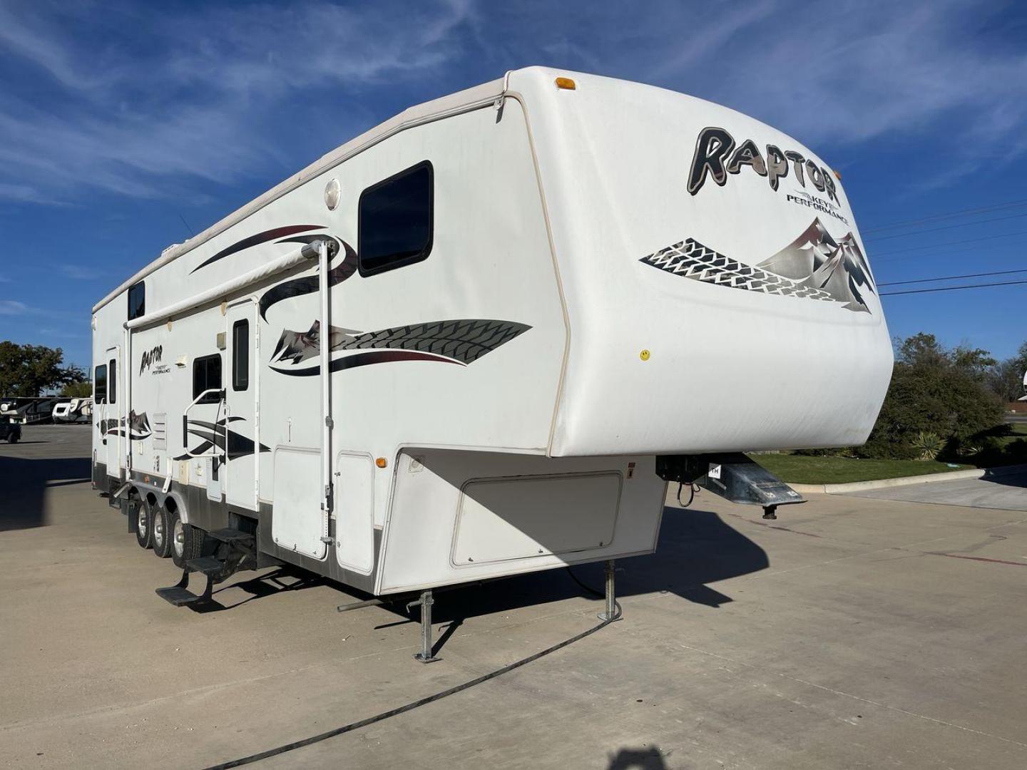 2006 KEYSTONE RAPTOR (4YDF361376M) , Length: 37.58 ft | Dry Weight: 11,615 lbs | Slides: 2 transmission, located at 4319 N Main Street, Cleburne, TX, 76033, (817) 221-0660, 32.435829, -97.384178 - The 2016 Keystone Raptor RP3612 is a fifth-wheel toy hauler with a bold and functional exterior. It features a white body with stylish decals that include swooping lines and mountain graphics, giving it a sporty and adventurous look. The RV has three axles, offering stability and support for its lar - Photo#22