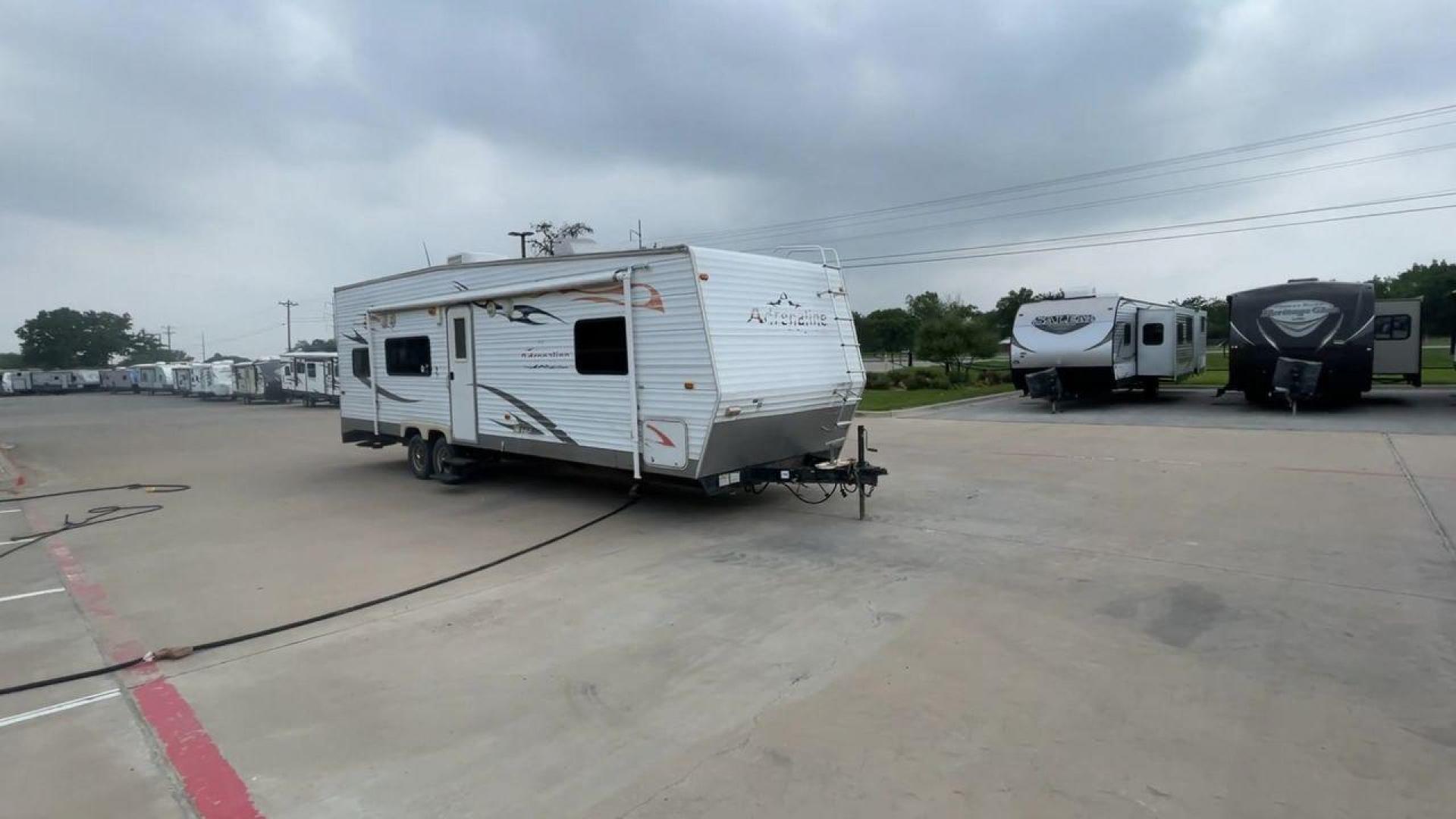 2008 WHITE ADRENALINE 23FS (1TC2B180683) , Length: 28.67 ft | Dry Weight: 6,474 lbs | Gross Weight: 9,500 lbs | Slides: 9 transmission, located at 4319 N Main Street, Cleburne, TX, 76033, (817) 221-0660, 32.435829, -97.384178 - The 2008 Adrenaline 23FS Toy Hauler is prepared for a journey! It is 28.67 feet long and weighs 6,474 pounds when dry. It's lightweight and portable, but large enough to hold all of your favorite toys and accessories. It can accommodate up to 9,500 pounds, so you'll have plenty of room for your next - Photo#3