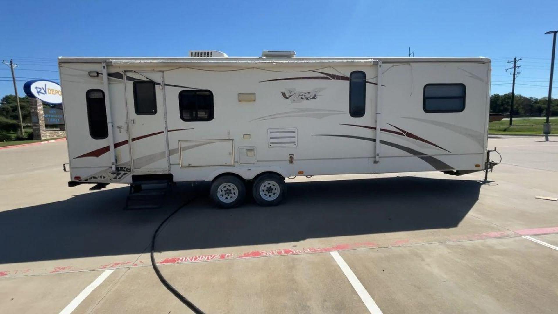 2008 WHITE VR-1 299RLS (4YDT299268V) , Length: 33 ft. | Dry Weight: 6,810 lbs. | Slides: 1 transmission, located at 4319 N Main Street, Cleburne, TX, 76033, (817) 221-0660, 32.435829, -97.384178 - The 2008 VR-1 299RLS is a dual-axle steel wheel setup measuring 33 ft. long and 11.17 ft. tall. It has a dry weight of 6,810 lbs. and a payload capacity of 2,805 lbs. It also has a hitch weight of 815 lbs. It includes one slide and one power awning. This travel trailer features a rear living floorpl - Photo#2