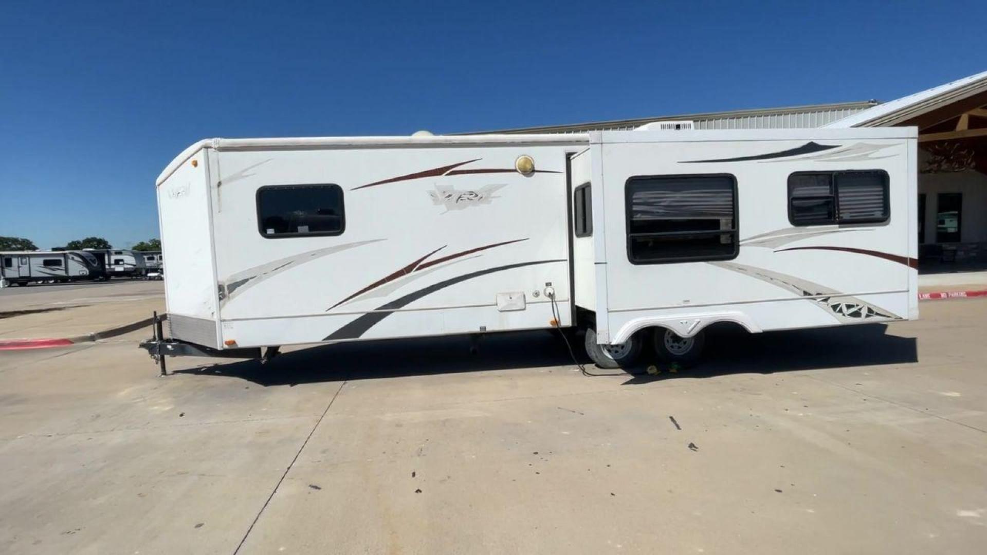 2008 WHITE VR-1 299RLS (4YDT299268V) , Length: 33 ft. | Dry Weight: 6,810 lbs. | Slides: 1 transmission, located at 4319 N Main Street, Cleburne, TX, 76033, (817) 221-0660, 32.435829, -97.384178 - The 2008 VR-1 299RLS is a dual-axle steel wheel setup measuring 33 ft. long and 11.17 ft. tall. It has a dry weight of 6,810 lbs. and a payload capacity of 2,805 lbs. It also has a hitch weight of 815 lbs. It includes one slide and one power awning. This travel trailer features a rear living floorpl - Photo#6