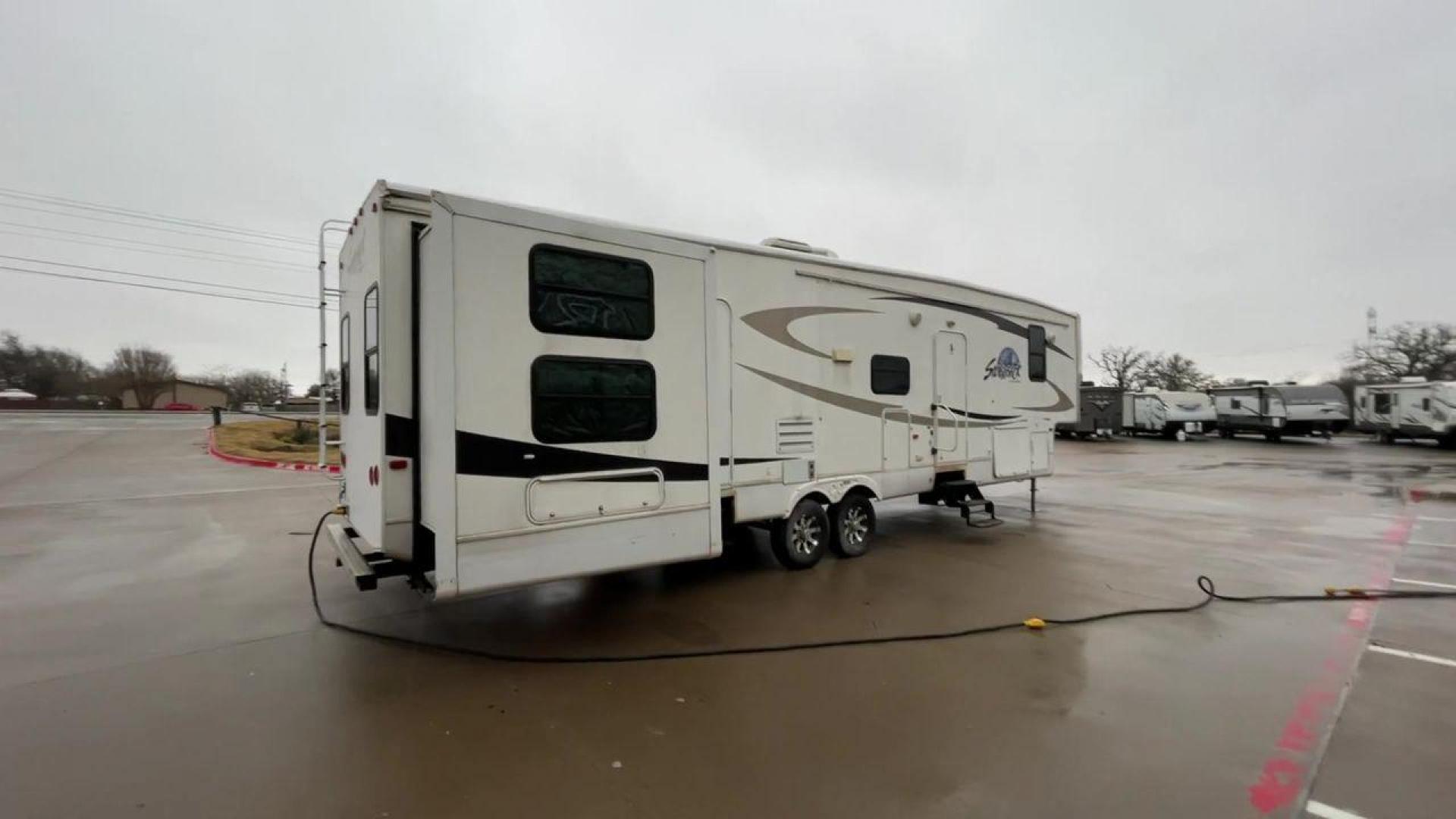 2010 WHITE CEDAR CREEK SILVERBA 35QB (4X4FCRL22AS) , Length: 41 ft.| Dry Weight: 12,184 lbs | Gross Weight: 15,500 lbs | Slides: 4 transmission, located at 4319 N Main Street, Cleburne, TX, 76033, (817) 221-0660, 32.435829, -97.384178 - With a length of 39 feet, the 35QB floor plan offers a private bunkhouse at the rear, ensuring a cozy retreat for the little ones or a group of friends. Its spacious living area with slide-outs expands the interior space for comfortable dining and entertainment. The kitchen is equipped with resident - Photo#1