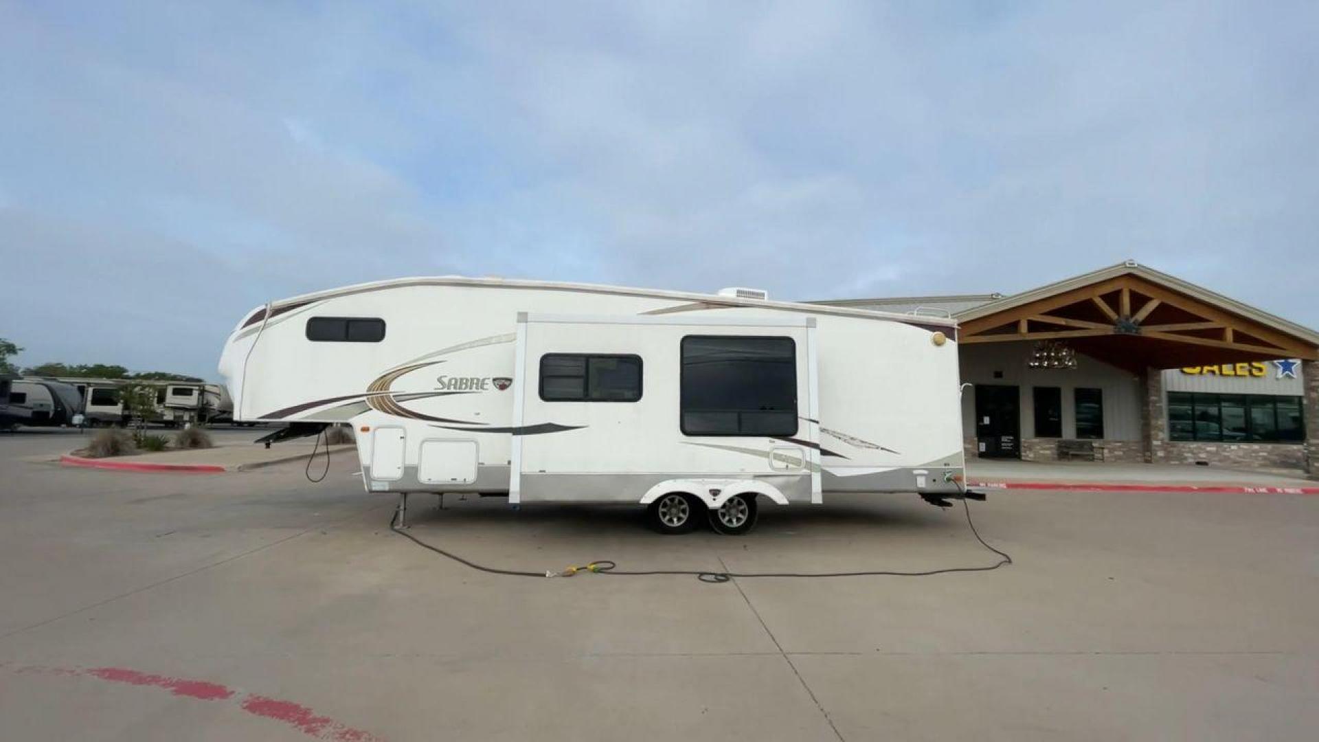 2010 WHITE FOREST RIVER SABRE 32QBDS - (4X4FSRH28A3) , Length: 35 ft. | Dry Weight: 9,235 lbs. | Gross Weight: 11,682 lbs. | Slides: 2 transmission, located at 4319 N Main Street, Cleburne, TX, 76033, (817) 221-0660, 32.435829, -97.384178 - This 2010 Forest River Sabre 32QBDS has a very family-friendly floor plan. It measures 35 ft in length and has a dry weight of 9,235 lbs. The gross weight is 11,682 lbs, and it has two slides. The door leads you to the central living and kitchen area. The living area comes with an entertainment cent - Photo#6