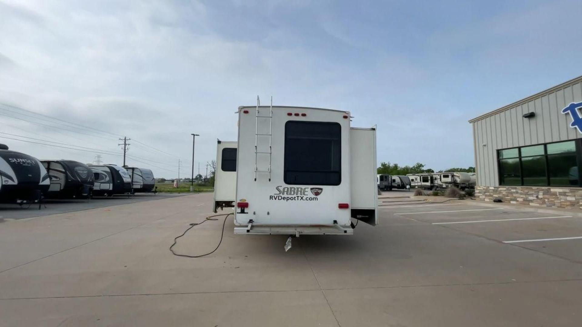 2010 WHITE FOREST RIVER SABRE 32QBDS - (4X4FSRH28A3) , Length: 35 ft. | Dry Weight: 9,235 lbs. | Gross Weight: 11,682 lbs. | Slides: 2 transmission, located at 4319 N Main Street, Cleburne, TX, 76033, (817) 221-0660, 32.435829, -97.384178 - This 2010 Forest River Sabre 32QBDS has a very family-friendly floor plan. It measures 35 ft in length and has a dry weight of 9,235 lbs. The gross weight is 11,682 lbs, and it has two slides. The door leads you to the central living and kitchen area. The living area comes with an entertainment cent - Photo#8