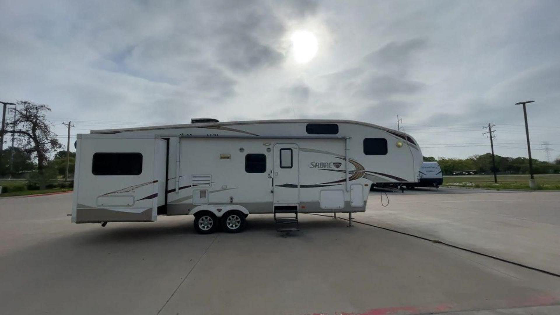 2010 WHITE FOREST RIVER SABRE 32QBDS - (4X4FSRH28A3) , Length: 35 ft. | Dry Weight: 9,235 lbs. | Gross Weight: 11,682 lbs. | Slides: 2 transmission, located at 4319 N Main Street, Cleburne, TX, 76033, (817) 221-0660, 32.435829, -97.384178 - This 2010 Forest River Sabre 32QBDS has a very family-friendly floor plan. It measures 35 ft in length and has a dry weight of 9,235 lbs. The gross weight is 11,682 lbs, and it has two slides. The door leads you to the central living and kitchen area. The living area comes with an entertainment cent - Photo#2