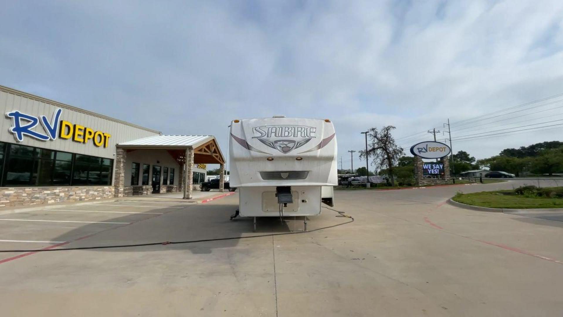 2010 WHITE FOREST RIVER SABRE 32QBDS - (4X4FSRH28A3) , Length: 35 ft. | Dry Weight: 9,235 lbs. | Gross Weight: 11,682 lbs. | Slides: 2 transmission, located at 4319 N Main Street, Cleburne, TX, 76033, (817) 221-0660, 32.435829, -97.384178 - This 2010 Forest River Sabre 32QBDS has a very family-friendly floor plan. It measures 35 ft in length and has a dry weight of 9,235 lbs. The gross weight is 11,682 lbs, and it has two slides. The door leads you to the central living and kitchen area. The living area comes with an entertainment cent - Photo#4