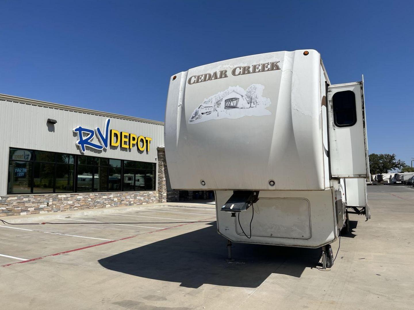 2011 WHITE CEDAR CREEK 36RE - (4X4FCRM24BS) , Length: 39 ft. | Dry Weight: 12,095 lbs. | Gross Weight: 15,500 lbs. | Slides: 3 transmission, located at 4319 N Main Street, Cleburne, TX, 76033, (817) 221-0660, 32.435829, -97.384178 - The 2011 Forest River Cedar Creek 36RE is a spacious and meticulously designed fifth-wheel RV, measuring 39 feet in length and 8 feet in width. With a dry weight of 12,095 lbs and a substantial GVWR of 15,500 lbs, this RV strikes a balance between size and towing efficiency. The aluminum superstruct - Photo#0