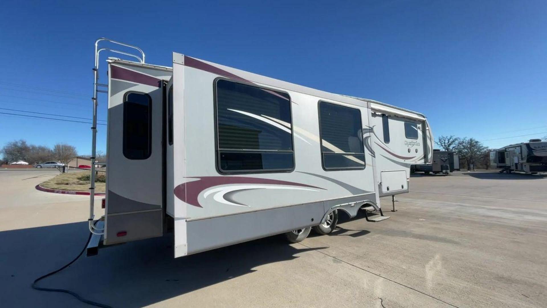 2011 WHITE HEARTLAND GREYSTONE 32RE (5SFSG3228BE) , Length: 34.83 ft. | Dry Weight: 10,421 lbs. | Gross Weight: 13,840 lbs. | Slides: 3 transmission, located at 4319 N Main Street, Cleburne, TX, 76033, (817) 221-0660, 32.435829, -97.384178 - This 2011 Heartland Greystone 32RE is a dual-axle aluminum wheel setup measuring nearly 35 feet long. It has a dry weight of 10,421 lbs. and a GVWR of 13,840 lbs. It includes three power slides as well as one 16-foot power awning. This unit features a classic rear living and front bedroom floor plan - Photo#1