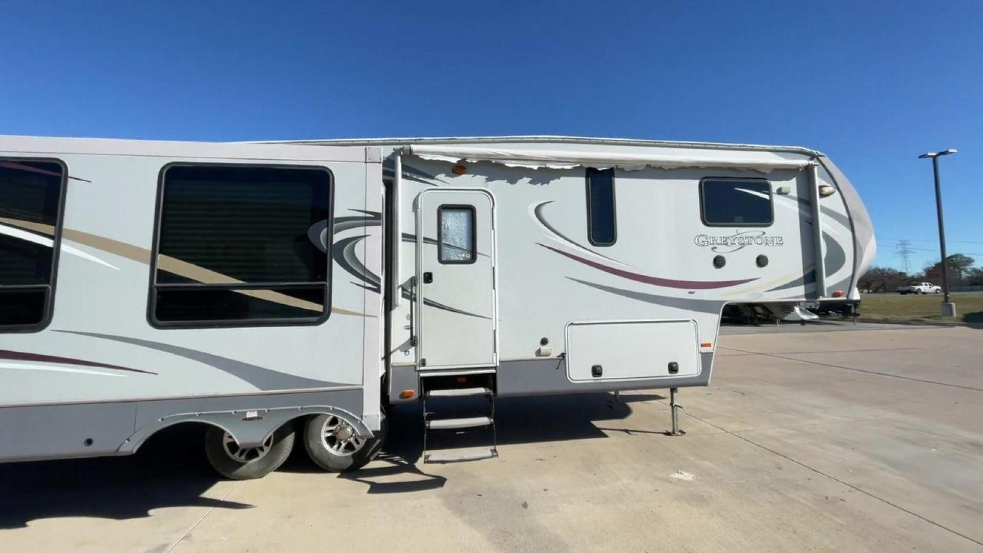 2011 WHITE HEARTLAND GREYSTONE 32RE (5SFSG3228BE) , Length: 34.83 ft. | Dry Weight: 10,421 lbs. | Gross Weight: 13,840 lbs. | Slides: 3 transmission, located at 4319 N Main Street, Cleburne, TX, 76033, (817) 221-0660, 32.435829, -97.384178 - This 2011 Heartland Greystone 32RE is a dual-axle aluminum wheel setup measuring nearly 35 feet long. It has a dry weight of 10,421 lbs. and a GVWR of 13,840 lbs. It includes three power slides as well as one 16-foot power awning. This unit features a classic rear living and front bedroom floor plan - Photo#2