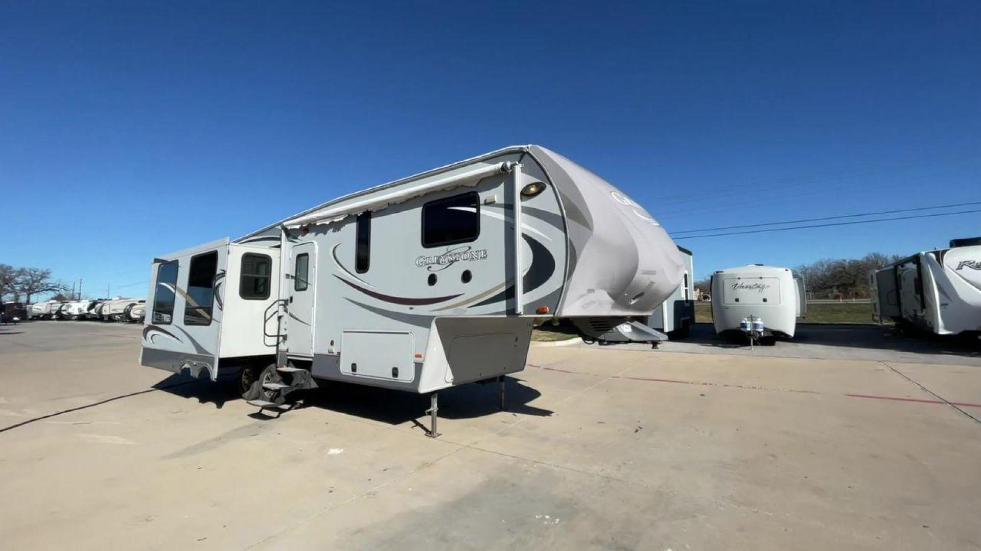 2011 WHITE HEARTLAND GREYSTONE 32RE (5SFSG3228BE) , Length: 34.83 ft. | Dry Weight: 10,421 lbs. | Gross Weight: 13,840 lbs. | Slides: 3 transmission, located at 4319 N Main Street, Cleburne, TX, 76033, (817) 221-0660, 32.435829, -97.384178 - This 2011 Heartland Greystone 32RE is a dual-axle aluminum wheel setup measuring nearly 35 feet long. It has a dry weight of 10,421 lbs. and a GVWR of 13,840 lbs. It includes three power slides as well as one 16-foot power awning. This unit features a classic rear living and front bedroom floor plan - Photo#3