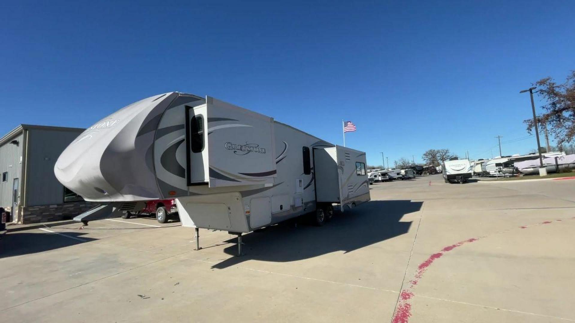 2011 WHITE HEARTLAND GREYSTONE 32RE (5SFSG3228BE) , Length: 34.83 ft. | Dry Weight: 10,421 lbs. | Gross Weight: 13,840 lbs. | Slides: 3 transmission, located at 4319 N Main Street, Cleburne, TX, 76033, (817) 221-0660, 32.435829, -97.384178 - This 2011 Heartland Greystone 32RE is a dual-axle aluminum wheel setup measuring nearly 35 feet long. It has a dry weight of 10,421 lbs. and a GVWR of 13,840 lbs. It includes three power slides as well as one 16-foot power awning. This unit features a classic rear living and front bedroom floor plan - Photo#5