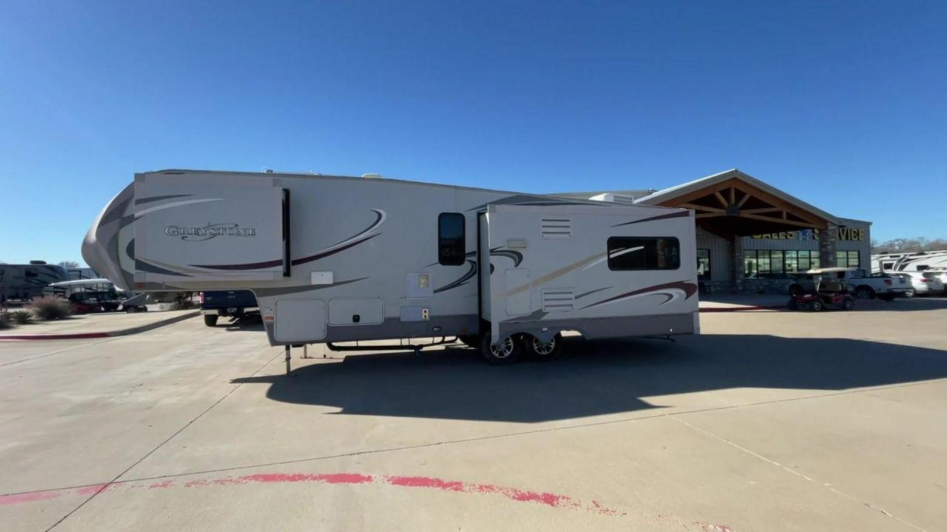 2011 WHITE HEARTLAND GREYSTONE 32RE (5SFSG3228BE) , Length: 34.83 ft. | Dry Weight: 10,421 lbs. | Gross Weight: 13,840 lbs. | Slides: 3 transmission, located at 4319 N Main Street, Cleburne, TX, 76033, (817) 221-0660, 32.435829, -97.384178 - This 2011 Heartland Greystone 32RE is a dual-axle aluminum wheel setup measuring nearly 35 feet long. It has a dry weight of 10,421 lbs. and a GVWR of 13,840 lbs. It includes three power slides as well as one 16-foot power awning. This unit features a classic rear living and front bedroom floor plan - Photo#6