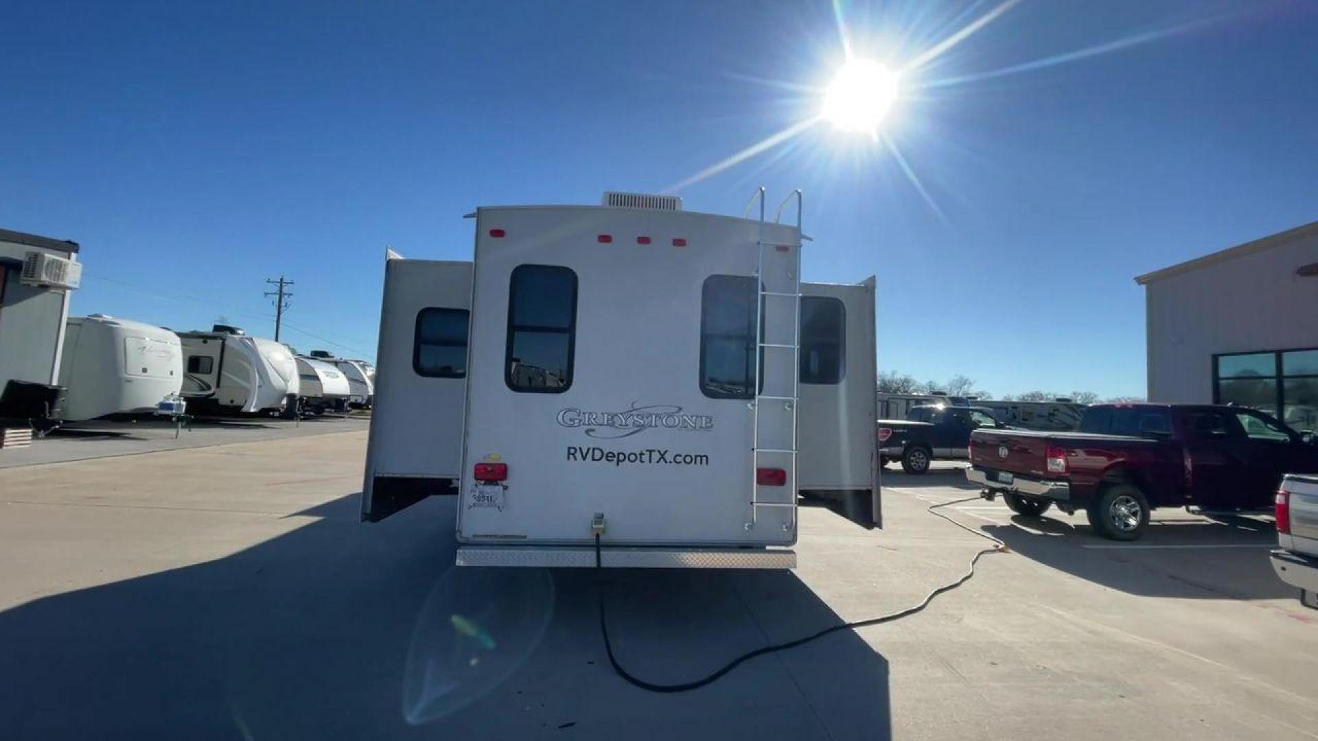 2011 WHITE HEARTLAND GREYSTONE 32RE (5SFSG3228BE) , Length: 34.83 ft. | Dry Weight: 10,421 lbs. | Gross Weight: 13,840 lbs. | Slides: 3 transmission, located at 4319 N Main Street, Cleburne, TX, 76033, (817) 221-0660, 32.435829, -97.384178 - This 2011 Heartland Greystone 32RE is a dual-axle aluminum wheel setup measuring nearly 35 feet long. It has a dry weight of 10,421 lbs. and a GVWR of 13,840 lbs. It includes three power slides as well as one 16-foot power awning. This unit features a classic rear living and front bedroom floor plan - Photo#8