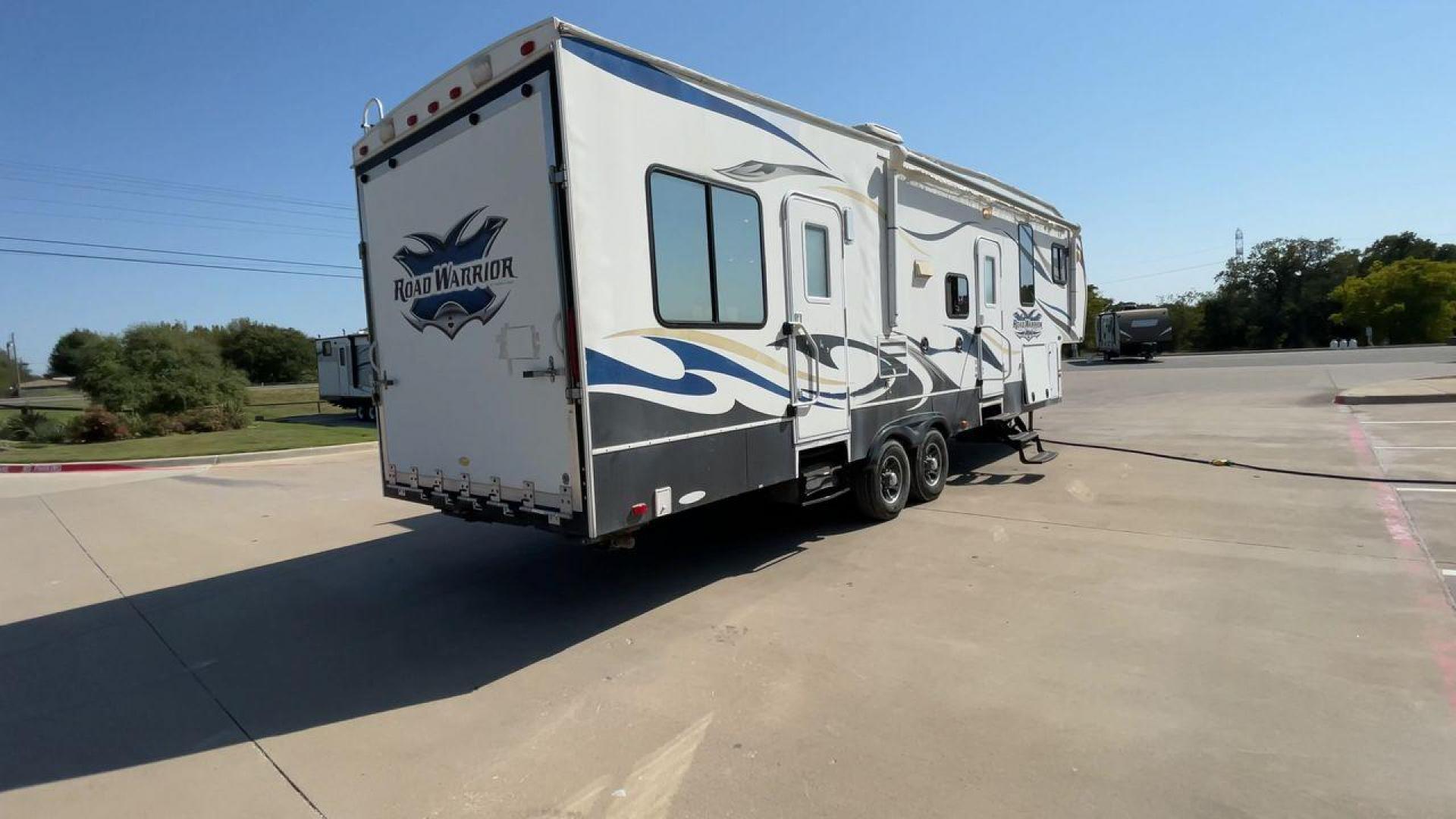 2011 WHITE HEARTLAND ROAD WARRIOR 305RW (5SFCG3021BE) , Length: 35.17 ft. | Dry Weight: 11,186 lbs. | Gross Weight: 14,000 lbs. | Slides: 2 transmission, located at 4319 N Main Street, Cleburne, TX, 76033, (817) 221-0660, 32.435829, -97.384178 - Embark on an adventure with your favorite toys in this 2011 Heartland Road Warrior 305RW! Being about 35-foot long and nearly 13-foot tall, this toy hauler offers you plenty of floor and ceiling space to load and store your toys and other bulky equipment. It also comes with two slides and an impr - Photo#1