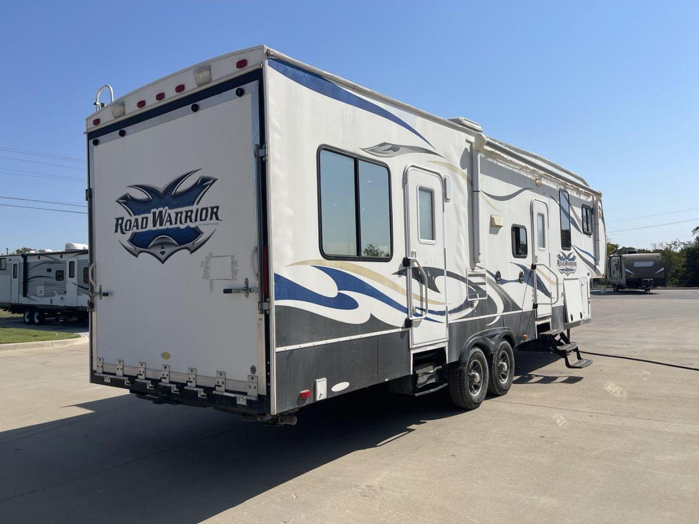 2011 WHITE HEARTLAND ROAD WARRIOR 305RW (5SFCG3021BE) , Length: 35.17 ft. | Dry Weight: 11,186 lbs. | Gross Weight: 14,000 lbs. | Slides: 2 transmission, located at 4319 N Main Street, Cleburne, TX, 76033, (817) 221-0660, 32.435829, -97.384178 - Embark on an adventure with your favorite toys in this 2011 Heartland Road Warrior 305RW! Being about 35-foot long and nearly 13-foot tall, this toy hauler offers you plenty of floor and ceiling space to load and store your toys and other bulky equipment. It also comes with two slides and an impr - Photo#23