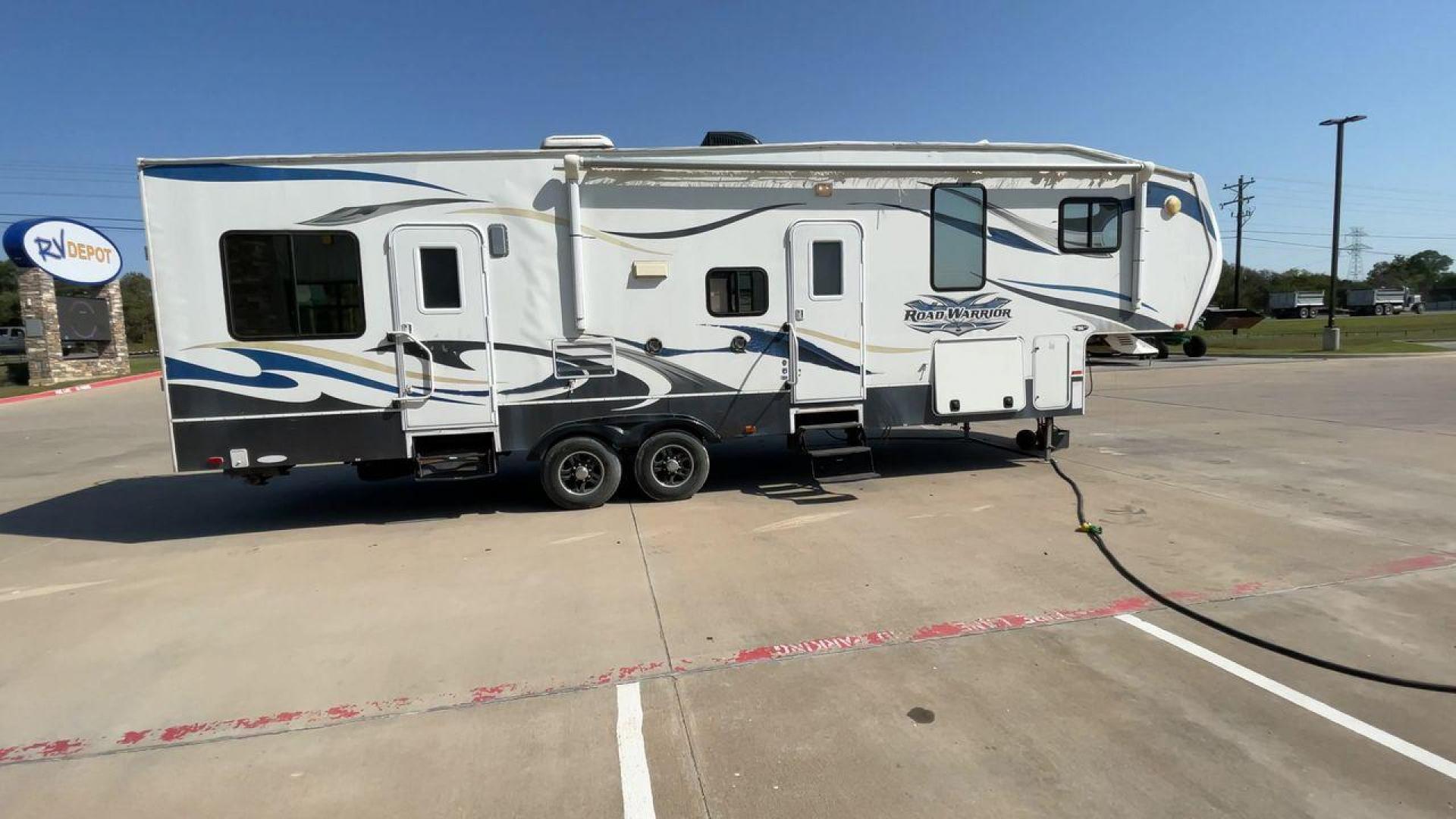 2011 WHITE HEARTLAND ROAD WARRIOR 305RW (5SFCG3021BE) , Length: 35.17 ft. | Dry Weight: 11,186 lbs. | Gross Weight: 14,000 lbs. | Slides: 2 transmission, located at 4319 N Main Street, Cleburne, TX, 76033, (817) 221-0660, 32.435829, -97.384178 - Embark on an adventure with your favorite toys in this 2011 Heartland Road Warrior 305RW! Being about 35-foot long and nearly 13-foot tall, this toy hauler offers you plenty of floor and ceiling space to load and store your toys and other bulky equipment. It also comes with two slides and an impr - Photo#2