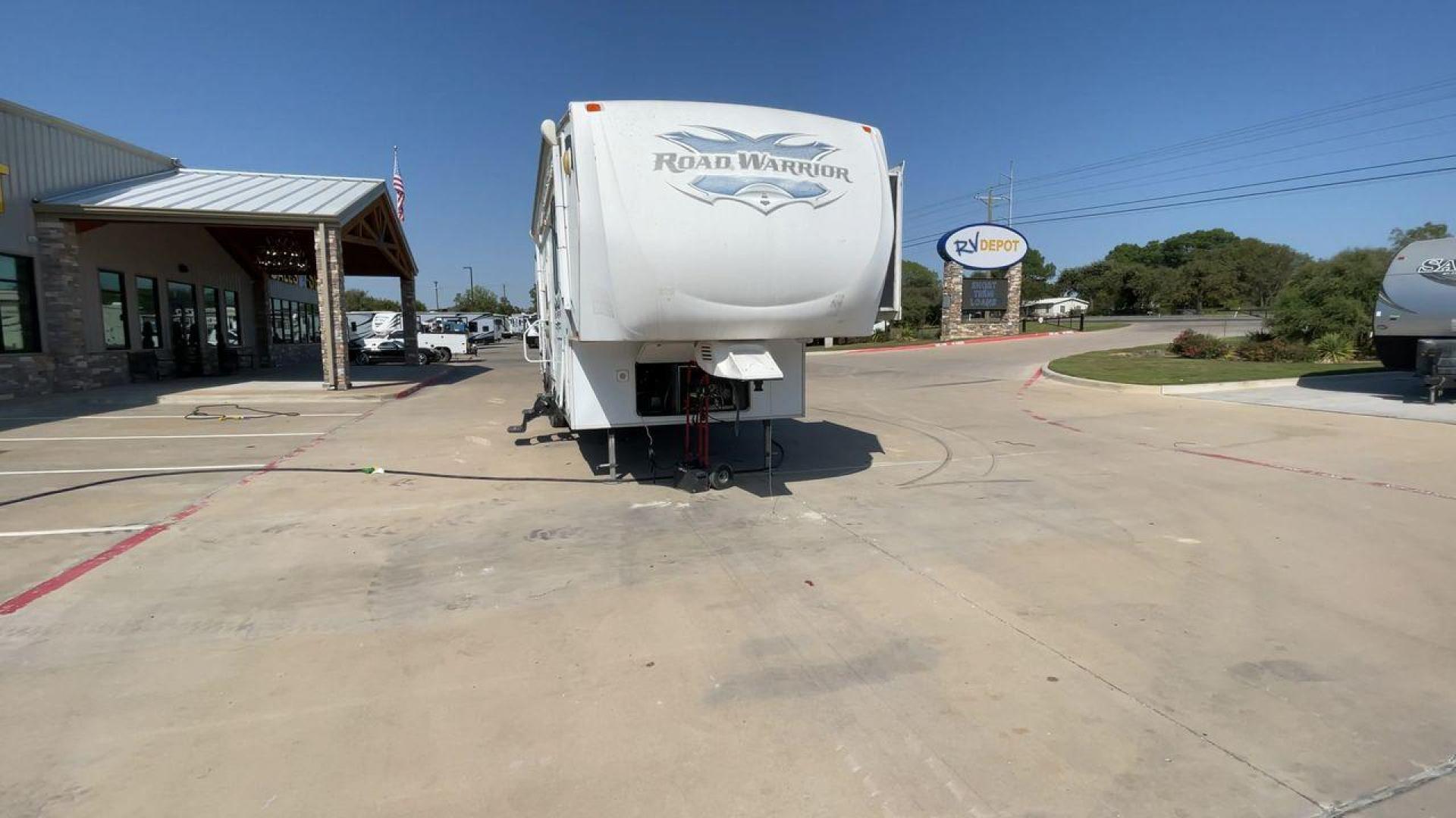 2011 WHITE HEARTLAND ROAD WARRIOR 305RW (5SFCG3021BE) , Length: 35.17 ft. | Dry Weight: 11,186 lbs. | Gross Weight: 14,000 lbs. | Slides: 2 transmission, located at 4319 N Main Street, Cleburne, TX, 76033, (817) 221-0660, 32.435829, -97.384178 - Embark on an adventure with your favorite toys in this 2011 Heartland Road Warrior 305RW! Being about 35-foot long and nearly 13-foot tall, this toy hauler offers you plenty of floor and ceiling space to load and store your toys and other bulky equipment. It also comes with two slides and an impr - Photo#4