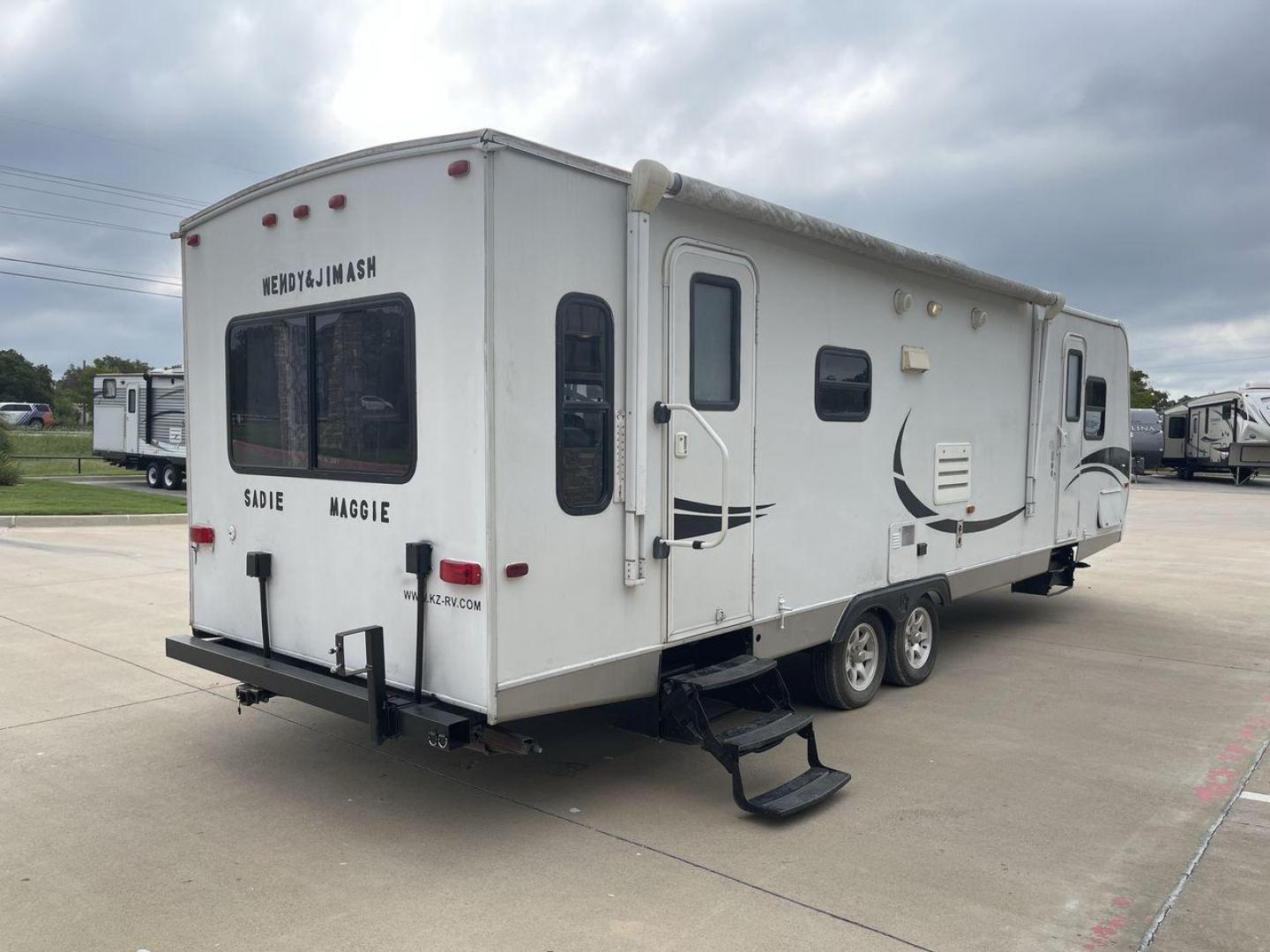 2011 KZ SPREE 323 RL (4EZTP3225B8) , located at 4319 N Main Street, Cleburne, TX, 76033, (817) 221-0660, 32.435829, -97.384178 - The 2011 KZSP CT features a clean and functional exterior design with practicality at its core. The white exterior is complemented by simple black graphic accents that stretch along the sides, providing a subtle yet stylish contrast. At the rear, the trailer includes a window for added natural light - Photo#25