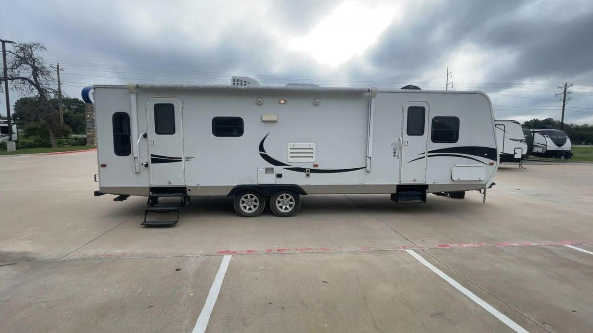 2011 KZ SPREE 323 RL (4EZTP3225B8) , located at 4319 N Main Street, Cleburne, TX, 76033, (817) 221-0660, 32.435829, -97.384178 - The 2011 KZSP CT features a clean and functional exterior design with practicality at its core. The white exterior is complemented by simple black graphic accents that stretch along the sides, providing a subtle yet stylish contrast. At the rear, the trailer includes a window for added natural light - Photo#2