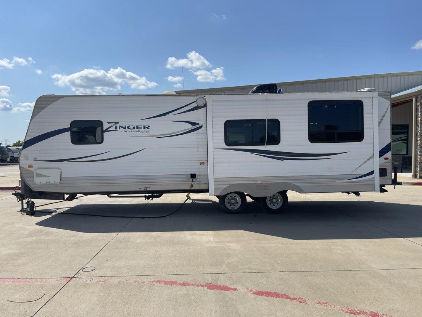 2012 CROSSROAD ZINGER 300RK - (4V0TC3024CA) , Length: 33.67 ft. | Dry Weight: 6,917 lbs. | Slides: 1 transmission, located at 4319 N Main Street, Cleburne, TX, 76033, (817) 221-0660, 32.435829, -97.384178 - The 2012 Crossroads Zinger 300RK is a well-designed travel trailer. At 33.67 ft long, this trailer offers a rear kitchen layout, slide-out living space, and a variety of amenities designed to make your home on the road as comfortable as possible. It showcases a sleek exterior with white aluminum sid - Photo#24