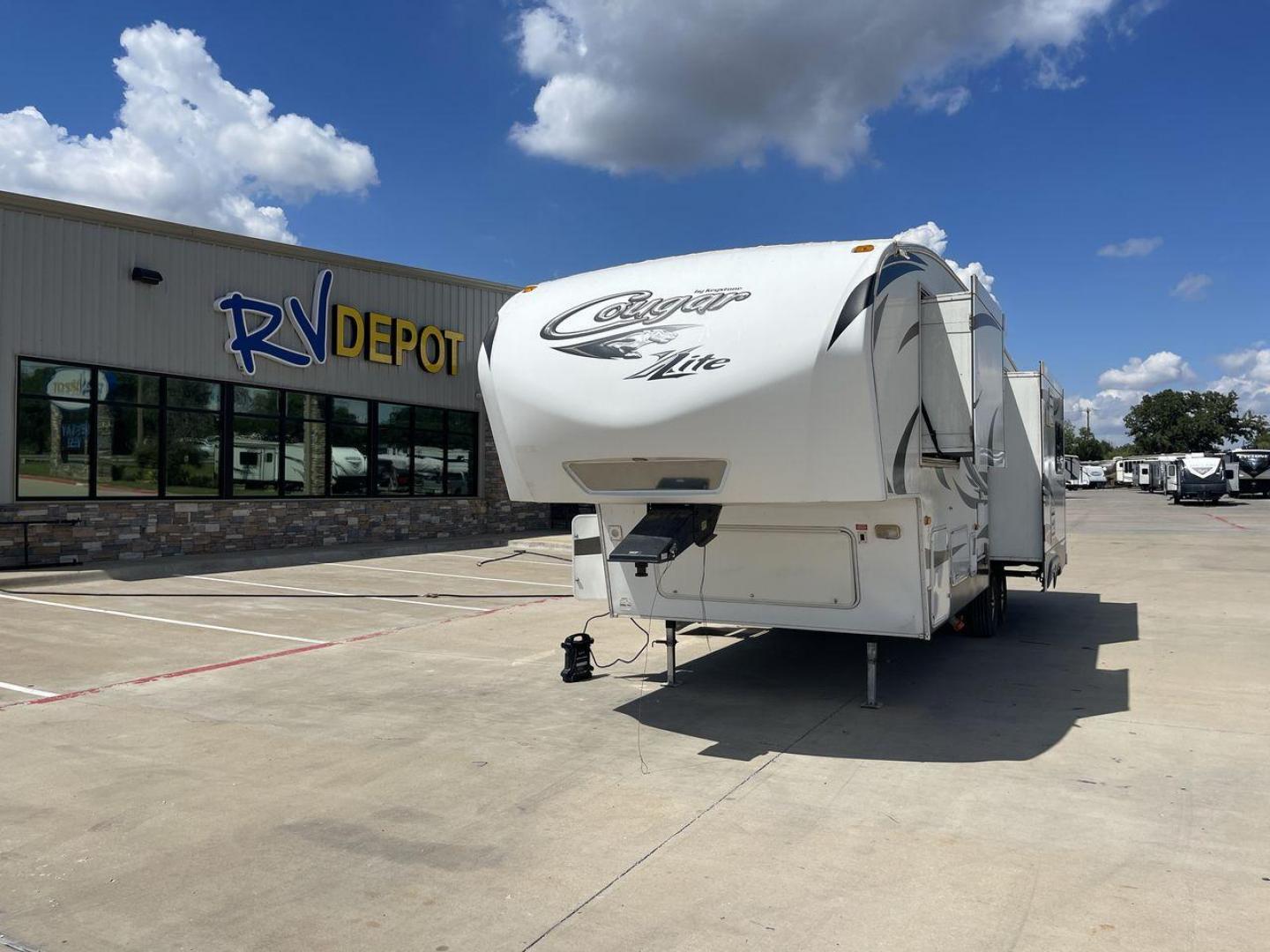 2012 BROWN KEYSTONE COUGAR 28SGS (4YDF28S25C2) , Length: 30.83 ft. | Dry Weight: 7,574 lbs. | Gross Weight: 10,000 lbs.| Slides: 3 transmission, located at 4319 N Main Street, Cleburne, TX, 76033, (817) 221-0660, 32.435829, -97.384178 - The 2012 Cougar 28SGS is a spacious fifth wheel that offers both comfort and style for your travel adventures. At 30.83 feet in length, this trailer features a dry weight of 7,574 lbs. and a gross weight of 10,000 lbs., making it a versatile option for towing with various vehicles. The Cougar is equ - Photo#0