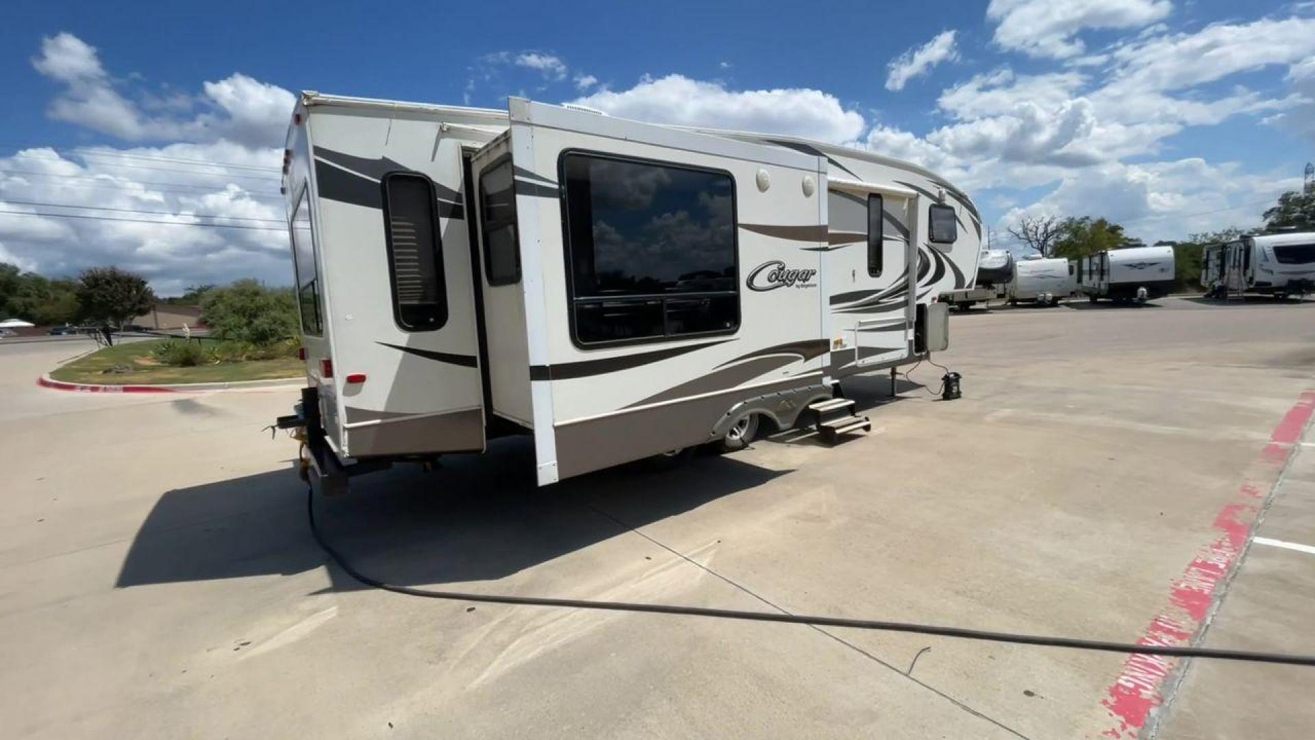 2012 BROWN KEYSTONE COUGAR 28SGS (4YDF28S25C2) , Length: 30.83 ft. | Dry Weight: 7,574 lbs. | Gross Weight: 10,000 lbs.| Slides: 3 transmission, located at 4319 N Main Street, Cleburne, TX, 76033, (817) 221-0660, 32.435829, -97.384178 - The 2012 Cougar 28SGS is a spacious fifth wheel that offers both comfort and style for your travel adventures. At 30.83 feet in length, this trailer features a dry weight of 7,574 lbs. and a gross weight of 10,000 lbs., making it a versatile option for towing with various vehicles. The Cougar is equ - Photo#1