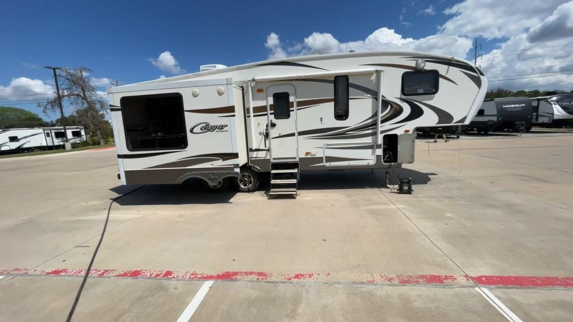 2012 BROWN KEYSTONE COUGAR 28SGS (4YDF28S25C2) , Length: 30.83 ft. | Dry Weight: 7,574 lbs. | Gross Weight: 10,000 lbs.| Slides: 3 transmission, located at 4319 N Main Street, Cleburne, TX, 76033, (817) 221-0660, 32.435829, -97.384178 - The 2012 Cougar 28SGS is a spacious fifth wheel that offers both comfort and style for your travel adventures. At 30.83 feet in length, this trailer features a dry weight of 7,574 lbs. and a gross weight of 10,000 lbs., making it a versatile option for towing with various vehicles. The Cougar is equ - Photo#2