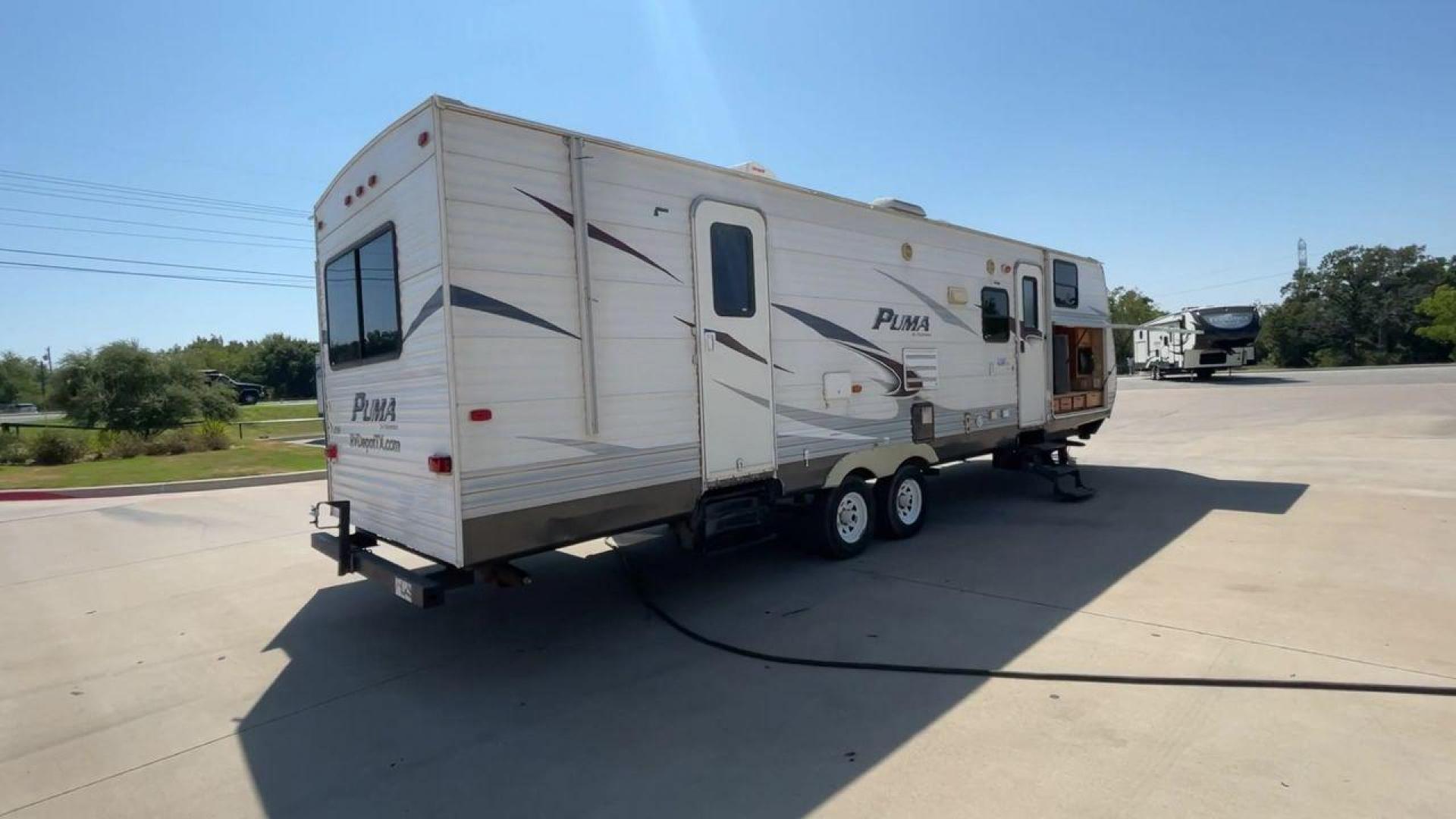 2012 WHITE PUMA 30KFB (4X4TPUF27CP) , Length: 34.75 ft. | Dry Weight: 8,130 lbs. | Gross Weight: 11,315 lbs. | Slides: 2 transmission, located at 4319 N Main Street, Cleburne, TX, 76033, (817) 221-0660, 32.435829, -97.384178 - The 2012 Puma 30KFB travel trailer has 34.75 ft length, 8 ft width, 11.08 ft height, and 6.67 ft interior height. The dry weight of this unit is about 8,130 lbs, with a payload capacity of 3,125 lbs. It has a GVWR of 11,315 lbs and a hitch weight of 1,155 lbs. This unit highlights an outdoor fro - Photo#1