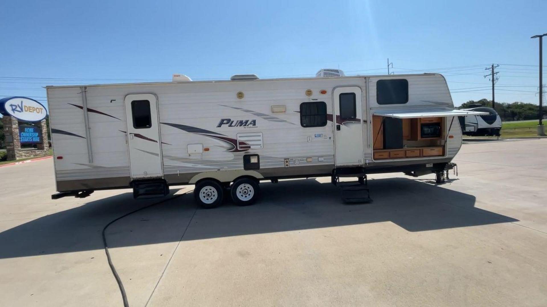 2012 WHITE PUMA 30KFB (4X4TPUF27CP) , Length: 34.75 ft. | Dry Weight: 8,130 lbs. | Gross Weight: 11,315 lbs. | Slides: 2 transmission, located at 4319 N Main Street, Cleburne, TX, 76033, (817) 221-0660, 32.435829, -97.384178 - The 2012 Puma 30KFB travel trailer has 34.75 ft length, 8 ft width, 11.08 ft height, and 6.67 ft interior height. The dry weight of this unit is about 8,130 lbs, with a payload capacity of 3,125 lbs. It has a GVWR of 11,315 lbs and a hitch weight of 1,155 lbs. This unit highlights an outdoor fro - Photo#2