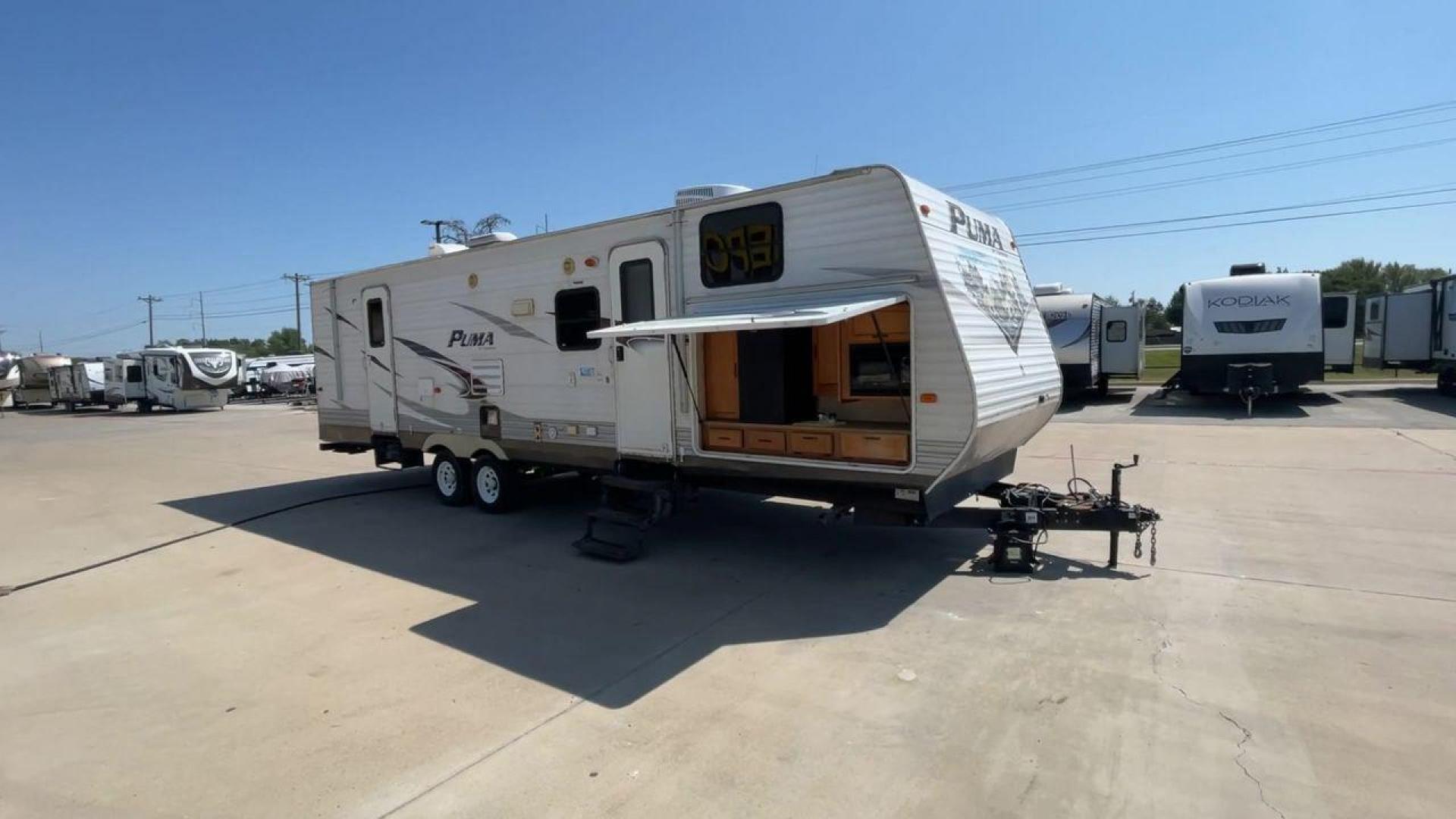 2012 WHITE PUMA 30KFB (4X4TPUF27CP) , Length: 34.75 ft. | Dry Weight: 8,130 lbs. | Gross Weight: 11,315 lbs. | Slides: 2 transmission, located at 4319 N Main Street, Cleburne, TX, 76033, (817) 221-0660, 32.435829, -97.384178 - The 2012 Puma 30KFB travel trailer has 34.75 ft length, 8 ft width, 11.08 ft height, and 6.67 ft interior height. The dry weight of this unit is about 8,130 lbs, with a payload capacity of 3,125 lbs. It has a GVWR of 11,315 lbs and a hitch weight of 1,155 lbs. This unit highlights an outdoor fro - Photo#3