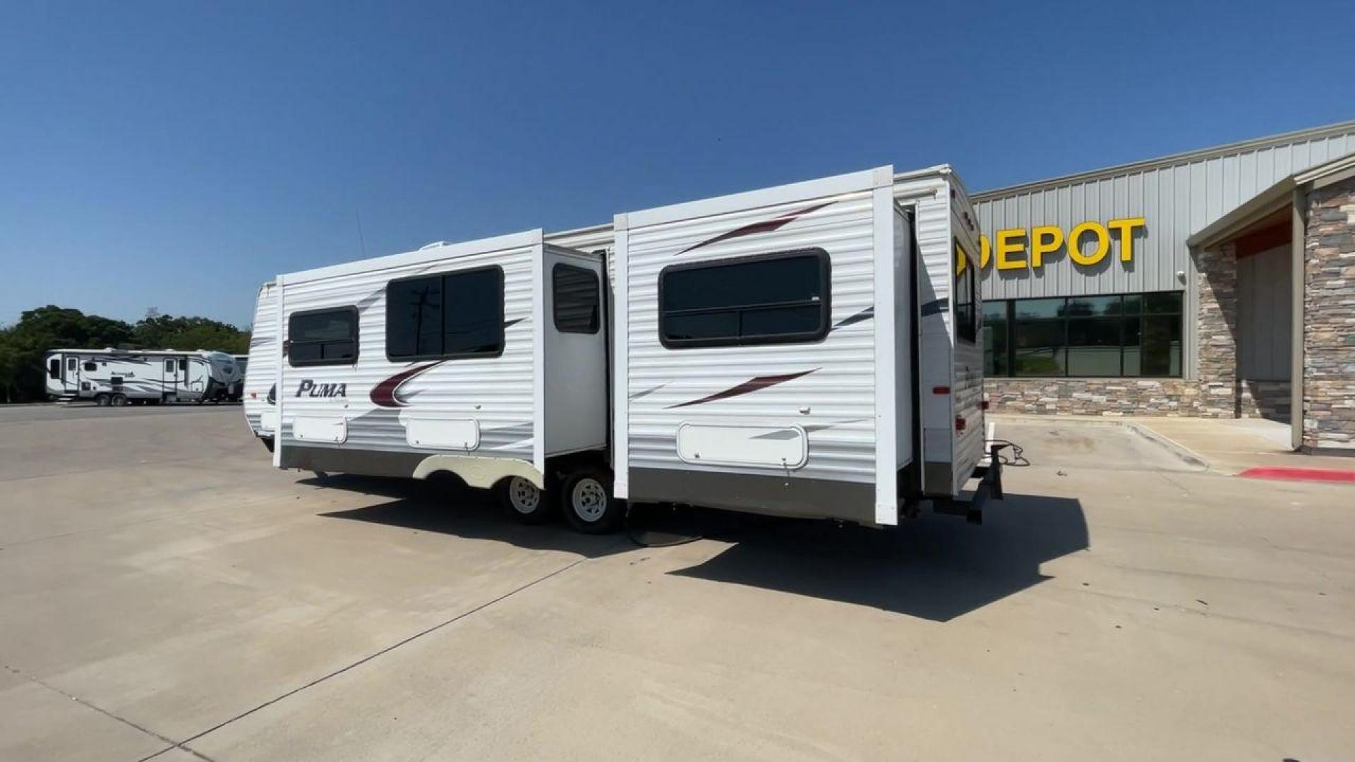 2012 WHITE PUMA 30KFB (4X4TPUF27CP) , Length: 34.75 ft. | Dry Weight: 8,130 lbs. | Gross Weight: 11,315 lbs. | Slides: 2 transmission, located at 4319 N Main Street, Cleburne, TX, 76033, (817) 221-0660, 32.435829, -97.384178 - The 2012 Puma 30KFB travel trailer has 34.75 ft length, 8 ft width, 11.08 ft height, and 6.67 ft interior height. The dry weight of this unit is about 8,130 lbs, with a payload capacity of 3,125 lbs. It has a GVWR of 11,315 lbs and a hitch weight of 1,155 lbs. This unit highlights an outdoor fro - Photo#7