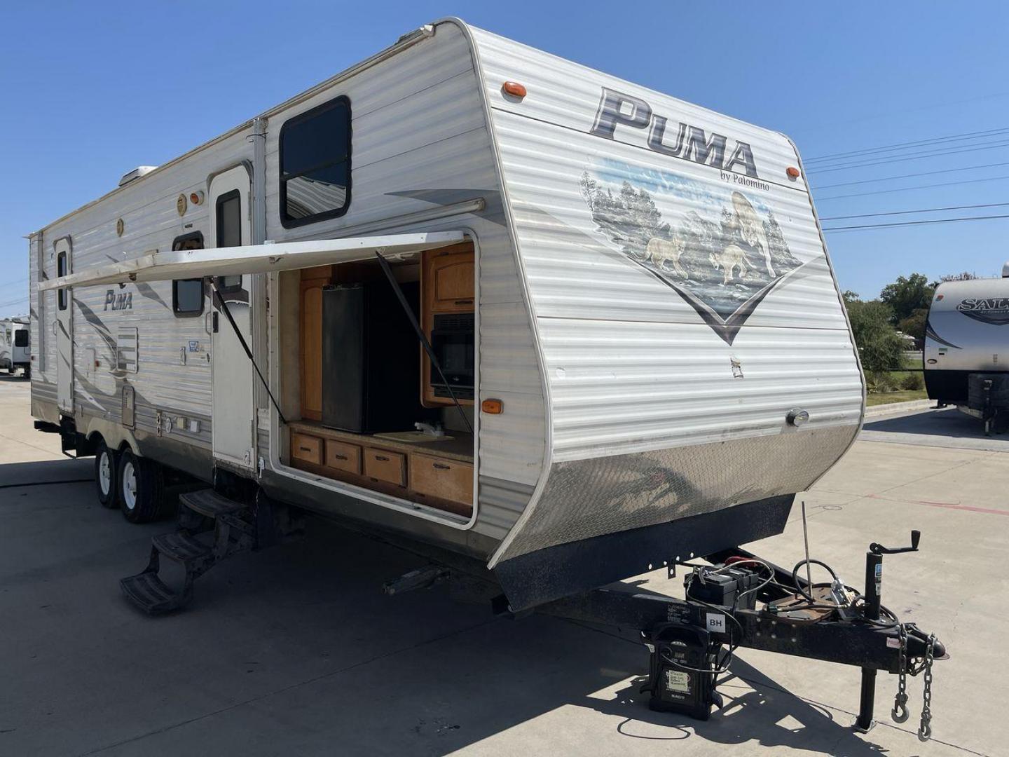 2012 WHITE PUMA 30KFB (4X4TPUF27CP) , Length: 34.75 ft. | Dry Weight: 8,130 lbs. | Gross Weight: 11,315 lbs. | Slides: 2 transmission, located at 4319 N Main Street, Cleburne, TX, 76033, (817) 221-0660, 32.435829, -97.384178 - The 2012 Puma 30KFB travel trailer has 34.75 ft length, 8 ft width, 11.08 ft height, and 6.67 ft interior height. The dry weight of this unit is about 8,130 lbs, with a payload capacity of 3,125 lbs. It has a GVWR of 11,315 lbs and a hitch weight of 1,155 lbs. This unit highlights an outdoor fro - Photo#23