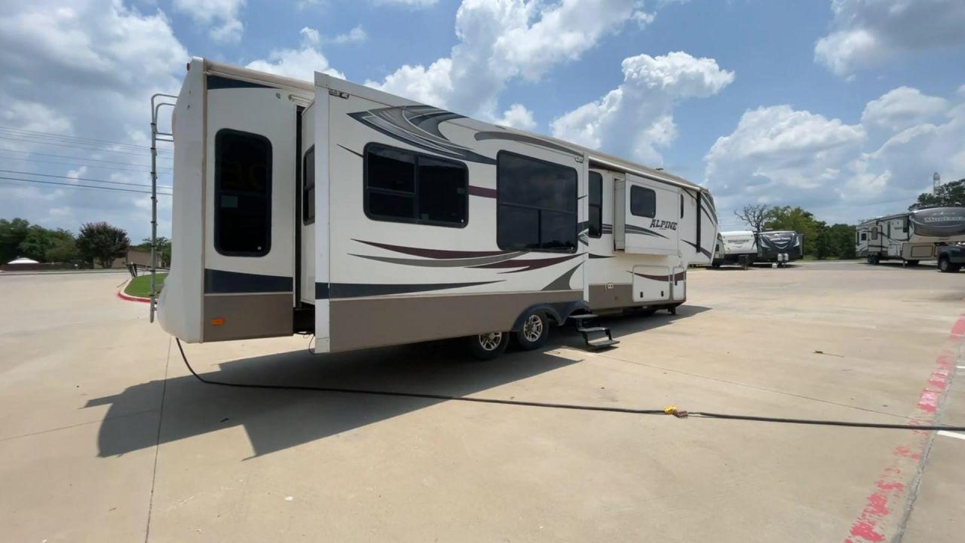 2013 WHITE KEYSTONE ALPNE 3720FB - (4YDF37227DE) , Length: 39.42 ft. | Dry Weight: 12,457 lbs. | Gross Weight: 15,500 lbs. | Slides: 4 transmission, located at 4319 N Main Street, Cleburne, TX, 76033, (817) 221-0660, 32.435829, -97.384178 - The 2013 Keystone Alpine 3720FB Travel Trailer provides a luxurious camping experience. This trailer is 39.42 feet long and has a dry weight of 12,457 lbs., providing plenty of space for relaxation and entertainment. Featuring four slides and convenient rear roof access, this RV offers ample space f - Photo#1