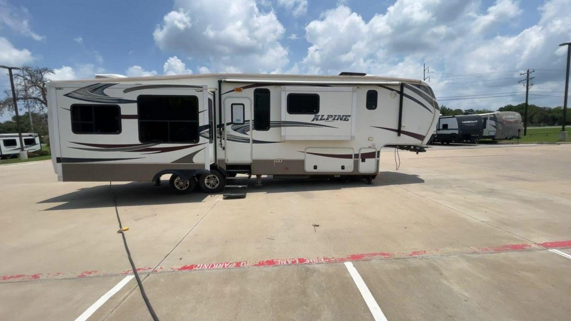 2013 WHITE KEYSTONE ALPNE 3720FB - (4YDF37227DE) , Length: 39.42 ft. | Dry Weight: 12,457 lbs. | Gross Weight: 15,500 lbs. | Slides: 4 transmission, located at 4319 N Main Street, Cleburne, TX, 76033, (817) 221-0660, 32.435829, -97.384178 - The 2013 Keystone Alpine 3720FB Travel Trailer provides a luxurious camping experience. This trailer is 39.42 feet long and has a dry weight of 12,457 lbs., providing plenty of space for relaxation and entertainment. Featuring four slides and convenient rear roof access, this RV offers ample space f - Photo#2