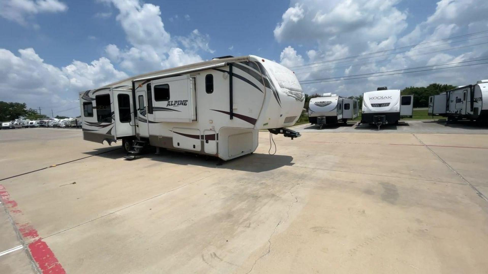 2013 WHITE KEYSTONE ALPNE 3720FB - (4YDF37227DE) , Length: 39.42 ft. | Dry Weight: 12,457 lbs. | Gross Weight: 15,500 lbs. | Slides: 4 transmission, located at 4319 N Main Street, Cleburne, TX, 76033, (817) 221-0660, 32.435829, -97.384178 - The 2013 Keystone Alpine 3720FB Travel Trailer provides a luxurious camping experience. This trailer is 39.42 feet long and has a dry weight of 12,457 lbs., providing plenty of space for relaxation and entertainment. Featuring four slides and convenient rear roof access, this RV offers ample space f - Photo#3