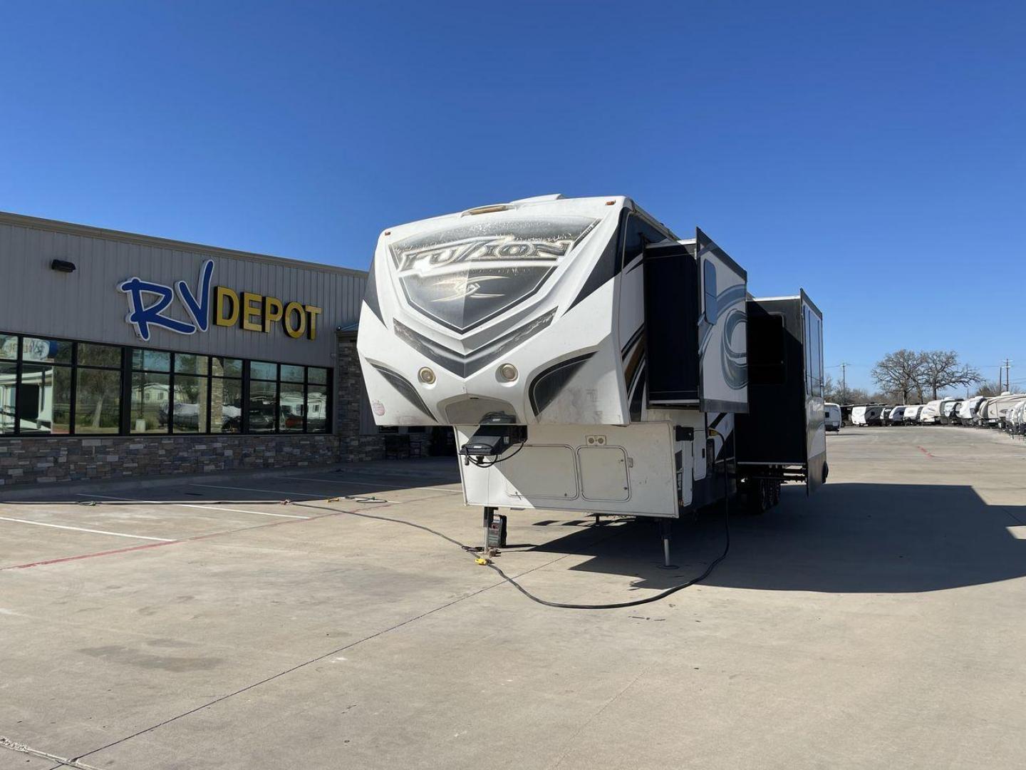 2013 WHITE KEYSTONE FUZION FZ399 - (4YDF39923DF) , Length: 41 ft. | Dry Weight: 13,880 lbs. | Gross Weight: 18,000 lbs. | Slides: 3 transmission, located at 4319 N Main Street, Cleburne, TX, 76033, (817) 221-0660, 32.435829, -97.384178 - The 2013 Keystone Fuzion FZ399 toy hauler measures 41 ft in length, 8.5 ft in width, and 13.25 ft in height. It has a dry weight of 13,880 lbs with a payload capacity of 4,120 lbs. The GVWR is 18,000 lbs and has a hitch weight of 3,560 lbs. This has a triple axle and triple slide with one 20 ft powe - Photo#0