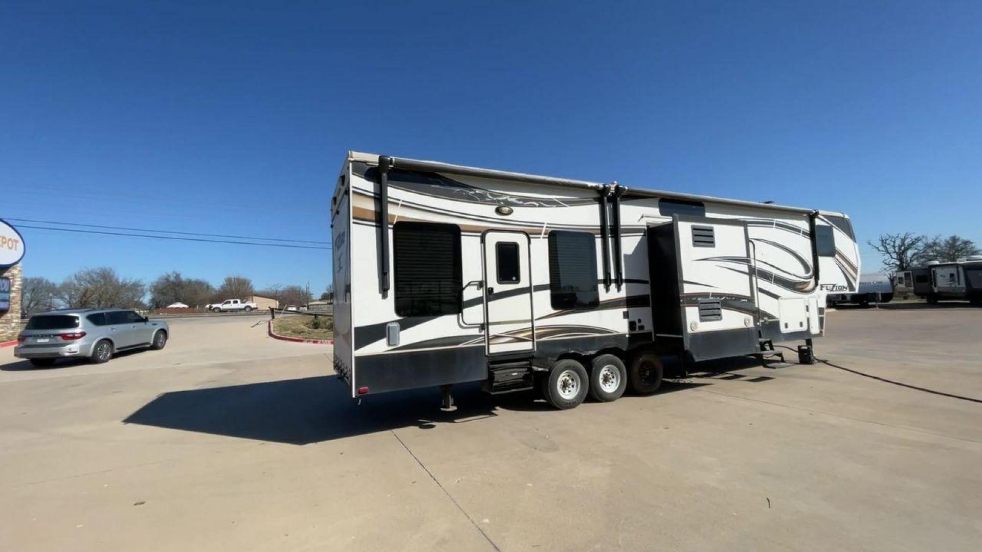 2013 WHITE KEYSTONE FUZION FZ399 - (4YDF39923DF) , Length: 41 ft. | Dry Weight: 13,880 lbs. | Gross Weight: 18,000 lbs. | Slides: 3 transmission, located at 4319 N Main Street, Cleburne, TX, 76033, (817) 221-0660, 32.435829, -97.384178 - The 2013 Keystone Fuzion FZ399 toy hauler measures 41 ft in length, 8.5 ft in width, and 13.25 ft in height. It has a dry weight of 13,880 lbs with a payload capacity of 4,120 lbs. The GVWR is 18,000 lbs and has a hitch weight of 3,560 lbs. This has a triple axle and triple slide with one 20 ft powe - Photo#1