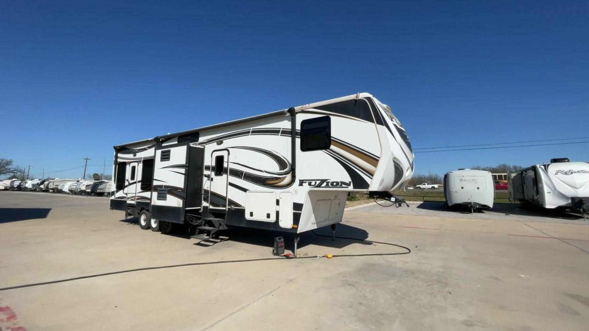 2013 WHITE KEYSTONE FUZION FZ399 - (4YDF39923DF) , Length: 41 ft. | Dry Weight: 13,880 lbs. | Gross Weight: 18,000 lbs. | Slides: 3 transmission, located at 4319 N Main Street, Cleburne, TX, 76033, (817) 221-0660, 32.435829, -97.384178 - The 2013 Keystone Fuzion FZ399 toy hauler measures 41 ft in length, 8.5 ft in width, and 13.25 ft in height. It has a dry weight of 13,880 lbs with a payload capacity of 4,120 lbs. The GVWR is 18,000 lbs and has a hitch weight of 3,560 lbs. This has a triple axle and triple slide with one 20 ft powe - Photo#3