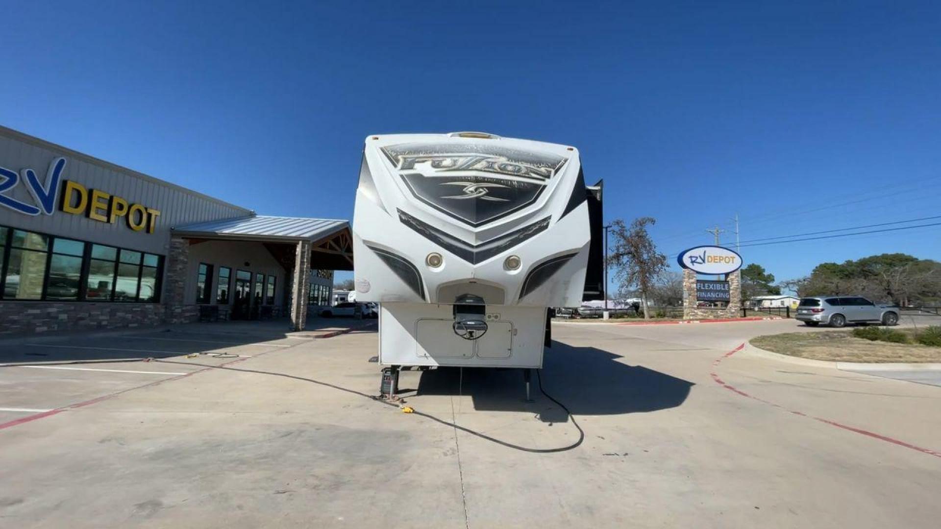 2013 WHITE KEYSTONE FUZION FZ399 - (4YDF39923DF) , Length: 41 ft. | Dry Weight: 13,880 lbs. | Gross Weight: 18,000 lbs. | Slides: 3 transmission, located at 4319 N Main Street, Cleburne, TX, 76033, (817) 221-0660, 32.435829, -97.384178 - The 2013 Keystone Fuzion FZ399 toy hauler measures 41 ft in length, 8.5 ft in width, and 13.25 ft in height. It has a dry weight of 13,880 lbs with a payload capacity of 4,120 lbs. The GVWR is 18,000 lbs and has a hitch weight of 3,560 lbs. This has a triple axle and triple slide with one 20 ft powe - Photo#4