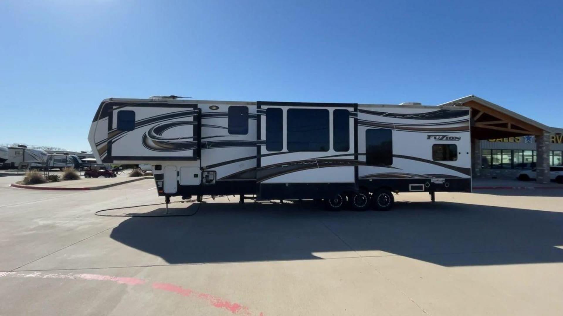 2013 WHITE KEYSTONE FUZION FZ399 - (4YDF39923DF) , Length: 41 ft. | Dry Weight: 13,880 lbs. | Gross Weight: 18,000 lbs. | Slides: 3 transmission, located at 4319 N Main Street, Cleburne, TX, 76033, (817) 221-0660, 32.435829, -97.384178 - The 2013 Keystone Fuzion FZ399 toy hauler measures 41 ft in length, 8.5 ft in width, and 13.25 ft in height. It has a dry weight of 13,880 lbs with a payload capacity of 4,120 lbs. The GVWR is 18,000 lbs and has a hitch weight of 3,560 lbs. This has a triple axle and triple slide with one 20 ft powe - Photo#6