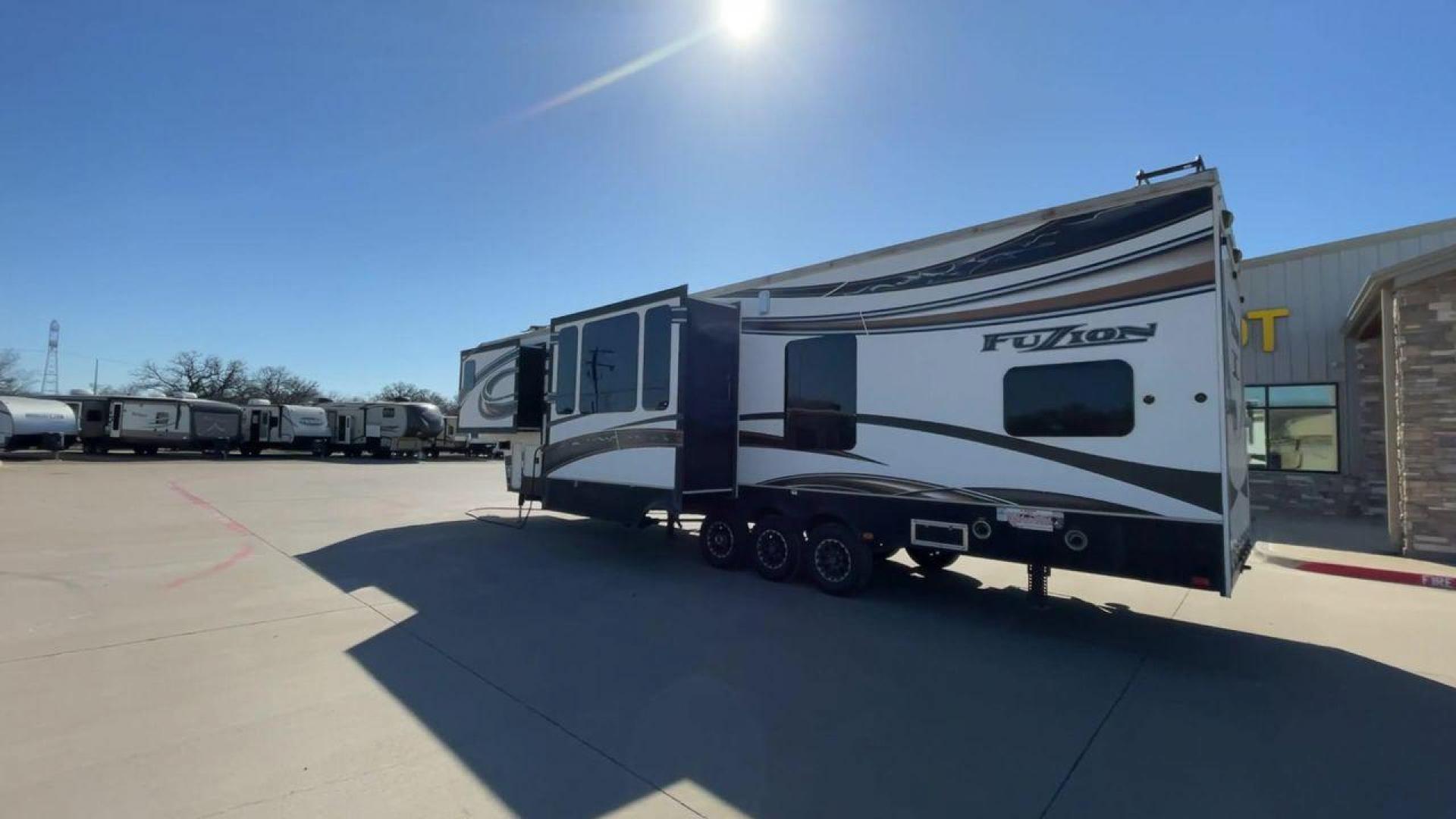 2013 WHITE KEYSTONE FUZION FZ399 - (4YDF39923DF) , Length: 41 ft. | Dry Weight: 13,880 lbs. | Gross Weight: 18,000 lbs. | Slides: 3 transmission, located at 4319 N Main Street, Cleburne, TX, 76033, (817) 221-0660, 32.435829, -97.384178 - The 2013 Keystone Fuzion FZ399 toy hauler measures 41 ft in length, 8.5 ft in width, and 13.25 ft in height. It has a dry weight of 13,880 lbs with a payload capacity of 4,120 lbs. The GVWR is 18,000 lbs and has a hitch weight of 3,560 lbs. This has a triple axle and triple slide with one 20 ft powe - Photo#7