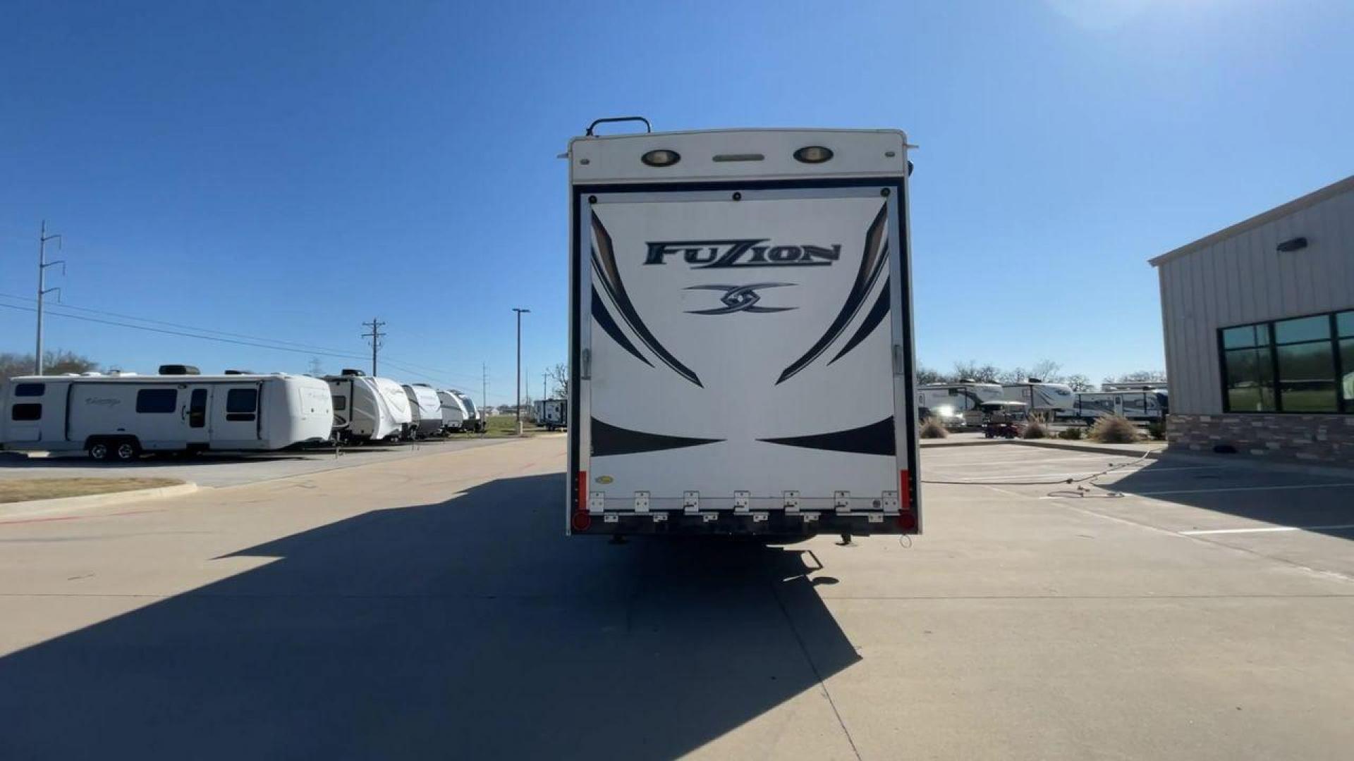 2013 WHITE KEYSTONE FUZION FZ399 - (4YDF39923DF) , Length: 41 ft. | Dry Weight: 13,880 lbs. | Gross Weight: 18,000 lbs. | Slides: 3 transmission, located at 4319 N Main Street, Cleburne, TX, 76033, (817) 221-0660, 32.435829, -97.384178 - The 2013 Keystone Fuzion FZ399 toy hauler measures 41 ft in length, 8.5 ft in width, and 13.25 ft in height. It has a dry weight of 13,880 lbs with a payload capacity of 4,120 lbs. The GVWR is 18,000 lbs and has a hitch weight of 3,560 lbs. This has a triple axle and triple slide with one 20 ft powe - Photo#8