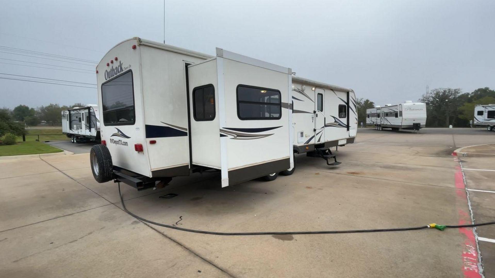 2013 KEYSTONE RV OUTBACK 298RE (4YDT29827DB) , Length: 35.17 ft.| Dry Weight: 7,443 lbs. | Gross Weight: 9,000 lbs. | Slides: 1 transmission, located at 4319 N Main Street, Cleburne, TX, 76033, (817) 221-0660, 32.435829, -97.384178 - The 2013 Keystone RV Outback 298RE is an ideal camping trailer for a family that sets out to the great outdoors every week. This unit has measurements of 35.17 ft in length, 8 ft in width, and 10.92 ft in height. The dry weight is about 7,443 lbs with a payload capacity of 1,557 lbs. It has a GV - Photo#1