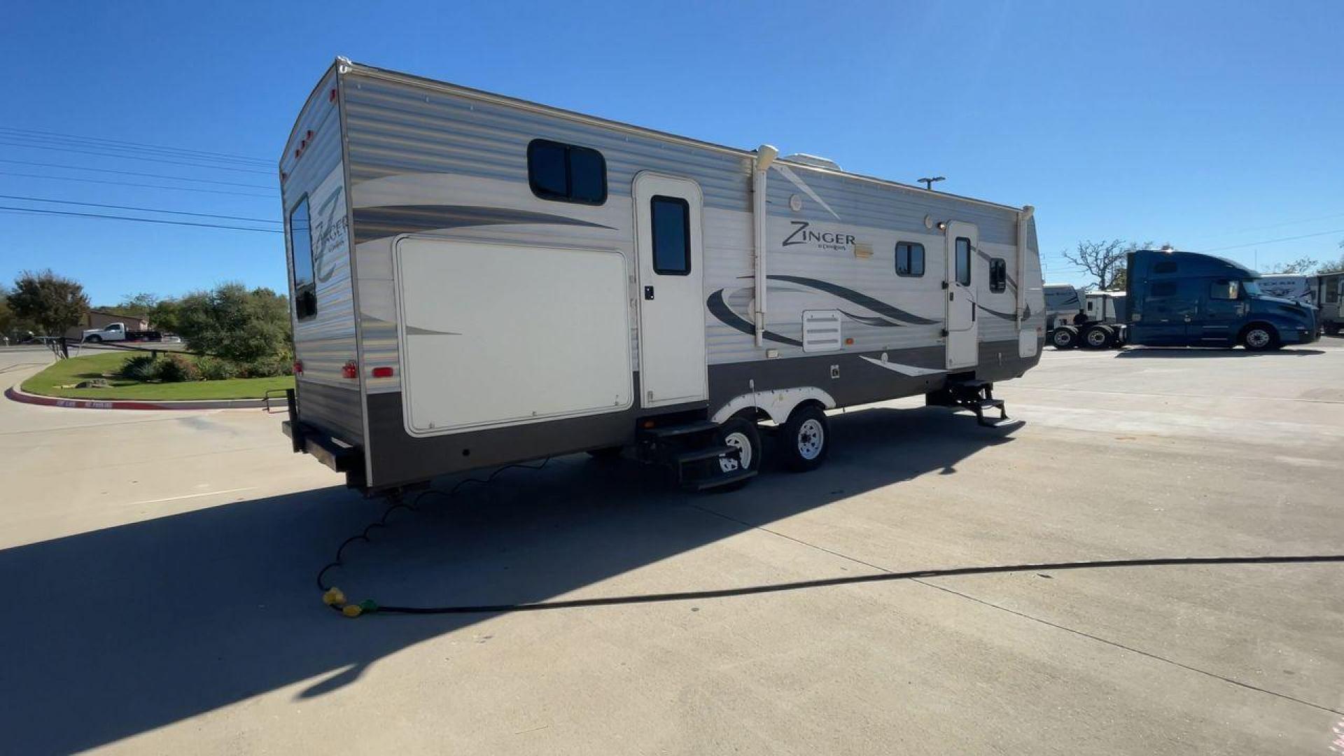 2013 WHITE ZINGER 31SB (4V0TC3129DJ) , Length: 35.5 ft. | Dry Weight: 7,875 lbs. | Gross Weight: 9,671 lbs. | Slides: 2 transmission, located at 4319 N Main Street, Cleburne, TX, 76033, (817) 221-0660, 32.435829, -97.384178 - This 2013 Zinger 31SB is a dual-axle steel wheel setup measuring 35.5 ft. long and 11.42 ft. tall. It has a dry weight of 7,875 lbs. and a GVWR of 9,671 lbs. It is designed with two doors, two slides, and one awning. The interior features two bedrooms, a bathroom, a kitchen, and a living area. The f - Photo#1