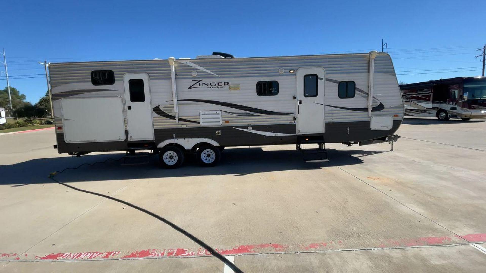 2013 WHITE ZINGER 31SB (4V0TC3129DJ) , Length: 35.5 ft. | Dry Weight: 7,875 lbs. | Gross Weight: 9,671 lbs. | Slides: 2 transmission, located at 4319 N Main Street, Cleburne, TX, 76033, (817) 221-0660, 32.435829, -97.384178 - This 2013 Zinger 31SB is a dual-axle steel wheel setup measuring 35.5 ft. long and 11.42 ft. tall. It has a dry weight of 7,875 lbs. and a GVWR of 9,671 lbs. It is designed with two doors, two slides, and one awning. The interior features two bedrooms, a bathroom, a kitchen, and a living area. The f - Photo#2