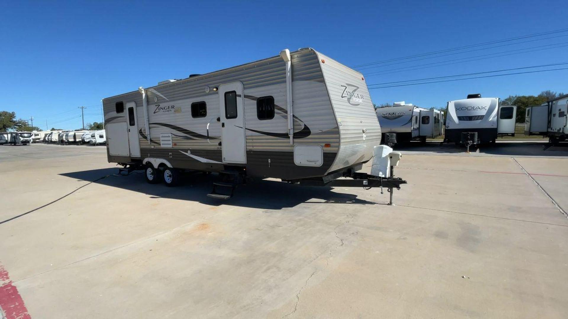 2013 WHITE ZINGER 31SB (4V0TC3129DJ) , Length: 35.5 ft. | Dry Weight: 7,875 lbs. | Gross Weight: 9,671 lbs. | Slides: 2 transmission, located at 4319 N Main Street, Cleburne, TX, 76033, (817) 221-0660, 32.435829, -97.384178 - This 2013 Zinger 31SB is a dual-axle steel wheel setup measuring 35.5 ft. long and 11.42 ft. tall. It has a dry weight of 7,875 lbs. and a GVWR of 9,671 lbs. It is designed with two doors, two slides, and one awning. The interior features two bedrooms, a bathroom, a kitchen, and a living area. The f - Photo#3