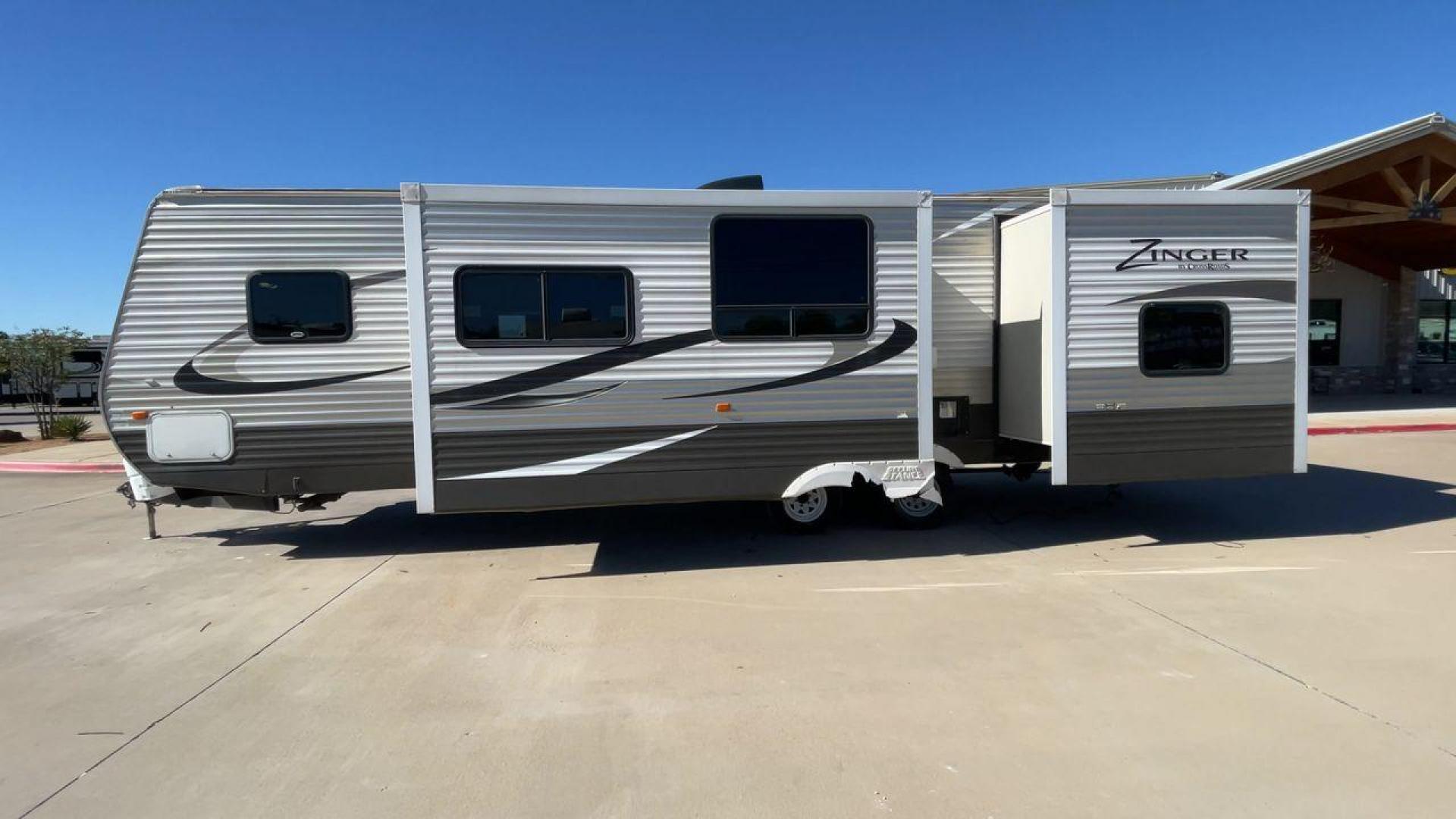 2013 WHITE ZINGER 31SB (4V0TC3129DJ) , Length: 35.5 ft. | Dry Weight: 7,875 lbs. | Gross Weight: 9,671 lbs. | Slides: 2 transmission, located at 4319 N Main Street, Cleburne, TX, 76033, (817) 221-0660, 32.435829, -97.384178 - This 2013 Zinger 31SB is a dual-axle steel wheel setup measuring 35.5 ft. long and 11.42 ft. tall. It has a dry weight of 7,875 lbs. and a GVWR of 9,671 lbs. It is designed with two doors, two slides, and one awning. The interior features two bedrooms, a bathroom, a kitchen, and a living area. The f - Photo#6