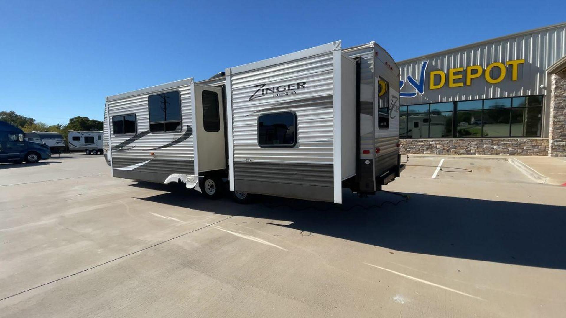 2013 WHITE ZINGER 31SB (4V0TC3129DJ) , Length: 35.5 ft. | Dry Weight: 7,875 lbs. | Gross Weight: 9,671 lbs. | Slides: 2 transmission, located at 4319 N Main Street, Cleburne, TX, 76033, (817) 221-0660, 32.435829, -97.384178 - This 2013 Zinger 31SB is a dual-axle steel wheel setup measuring 35.5 ft. long and 11.42 ft. tall. It has a dry weight of 7,875 lbs. and a GVWR of 9,671 lbs. It is designed with two doors, two slides, and one awning. The interior features two bedrooms, a bathroom, a kitchen, and a living area. The f - Photo#7